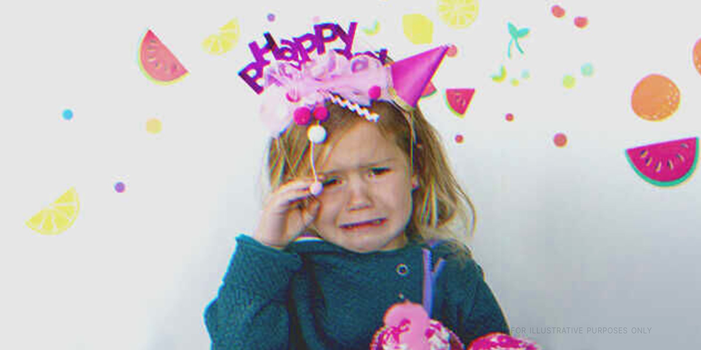 Girl with birthday hat crying. | Source: Getty Images