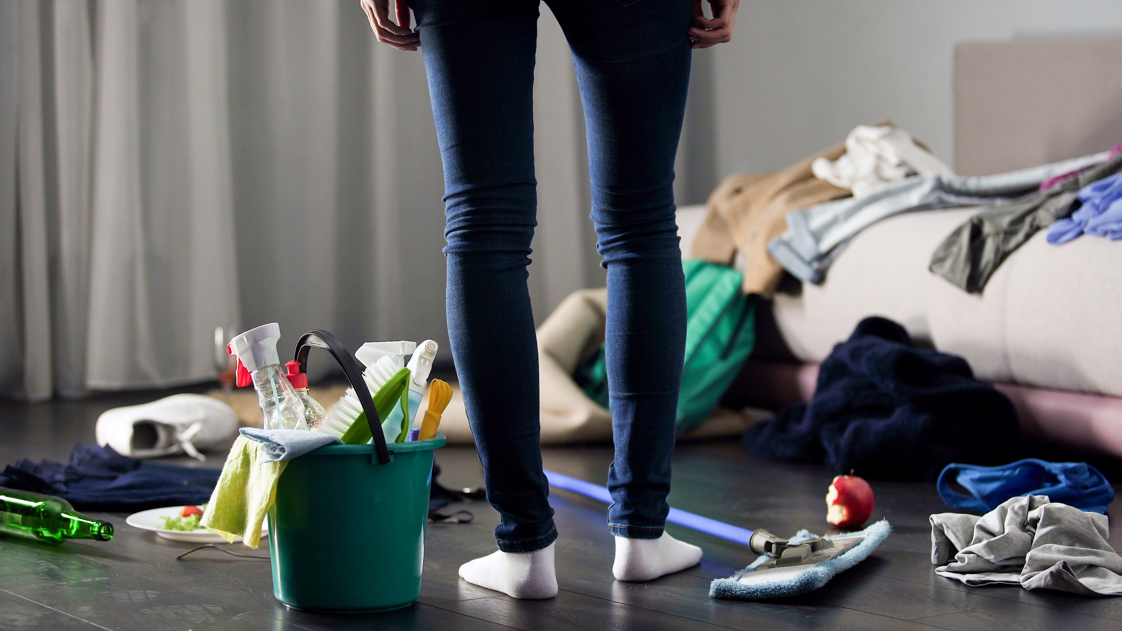 A woman standing in a messy room | Source: Shutterstock