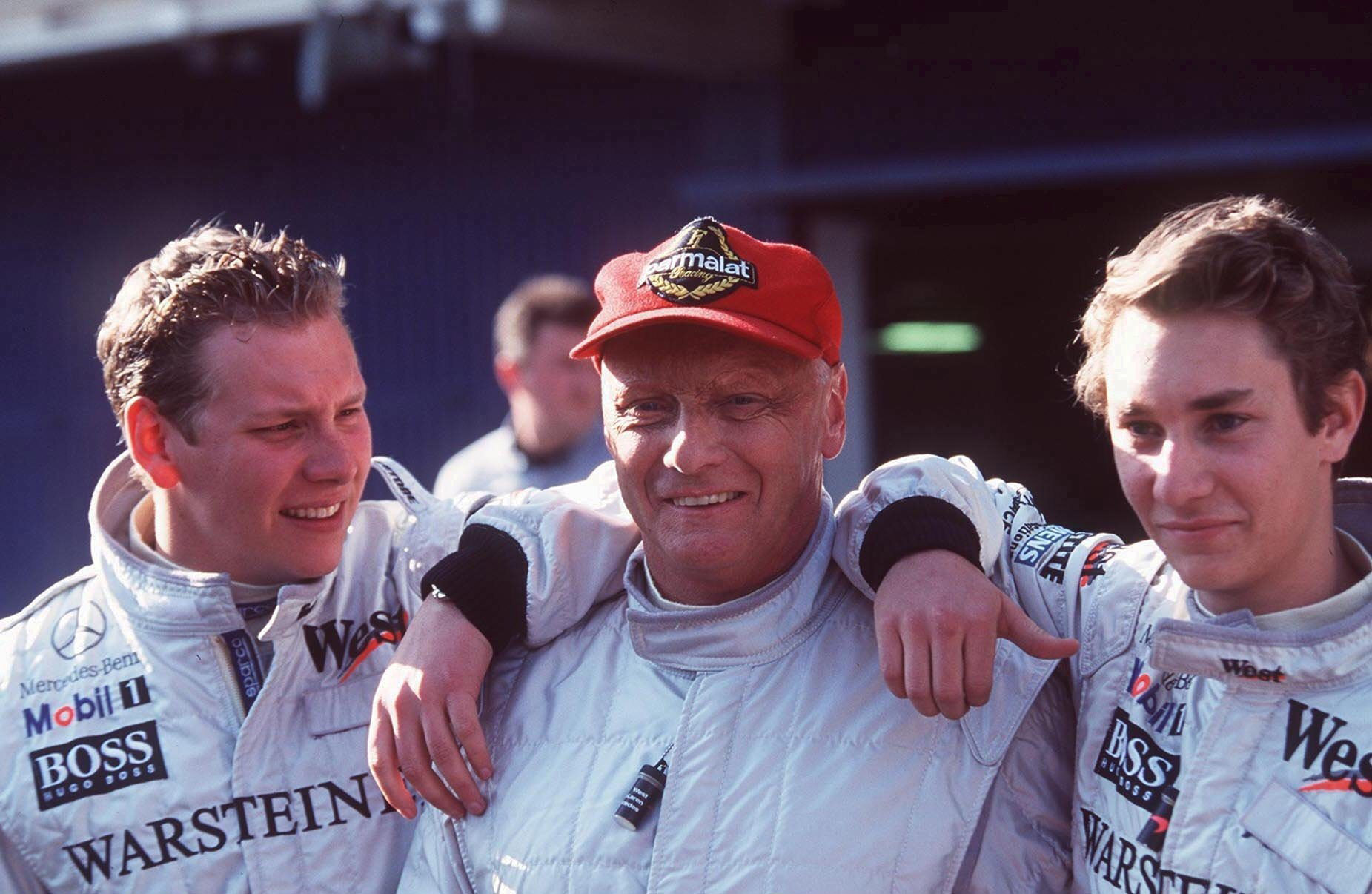Lukas Lauda, his father Niki, and brother Mathias at the Circuit de Barcelona-Catalunya on February 7, 1999, in Spain. | Source: Getty Images