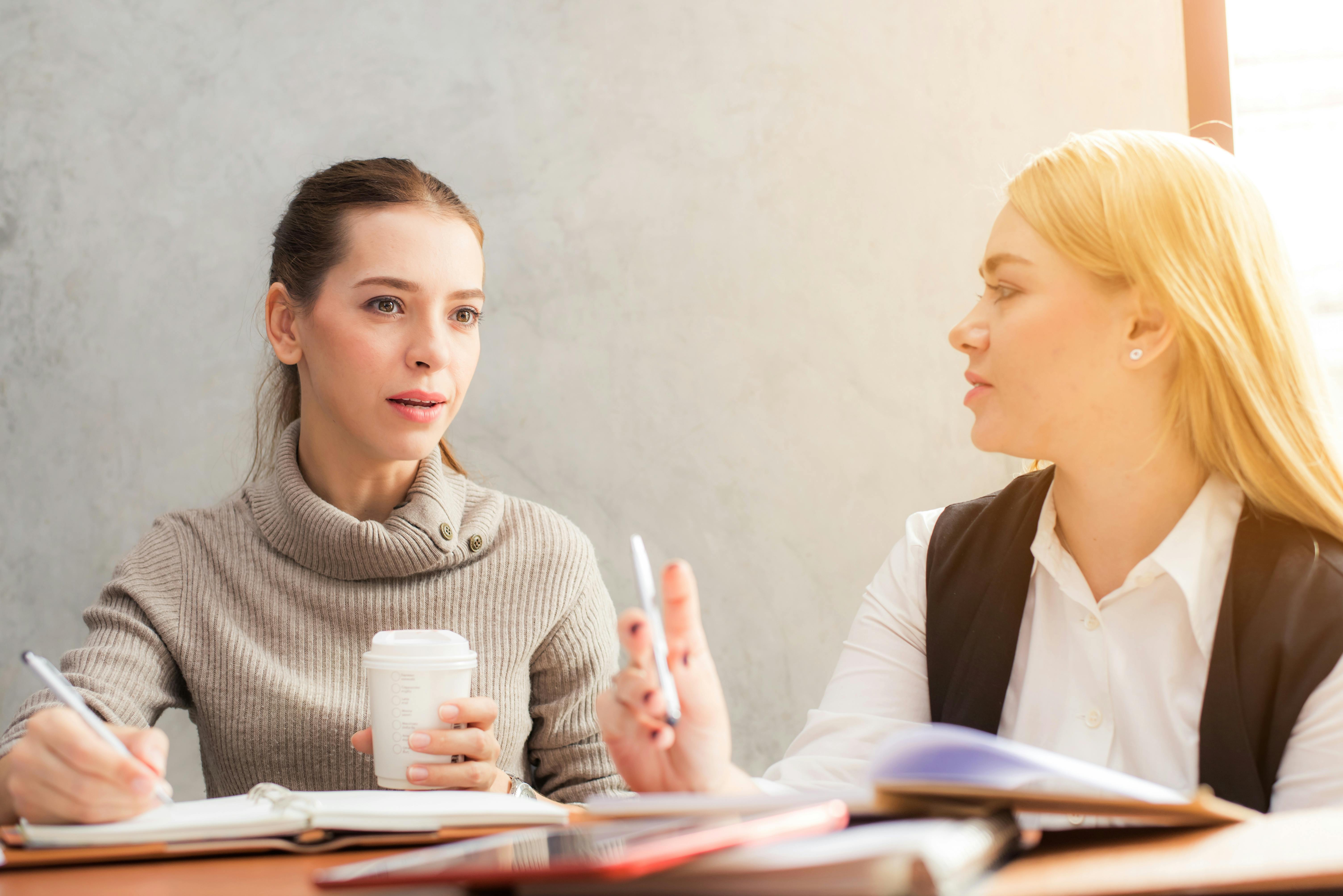 Two women discuss work | Source: Pexels