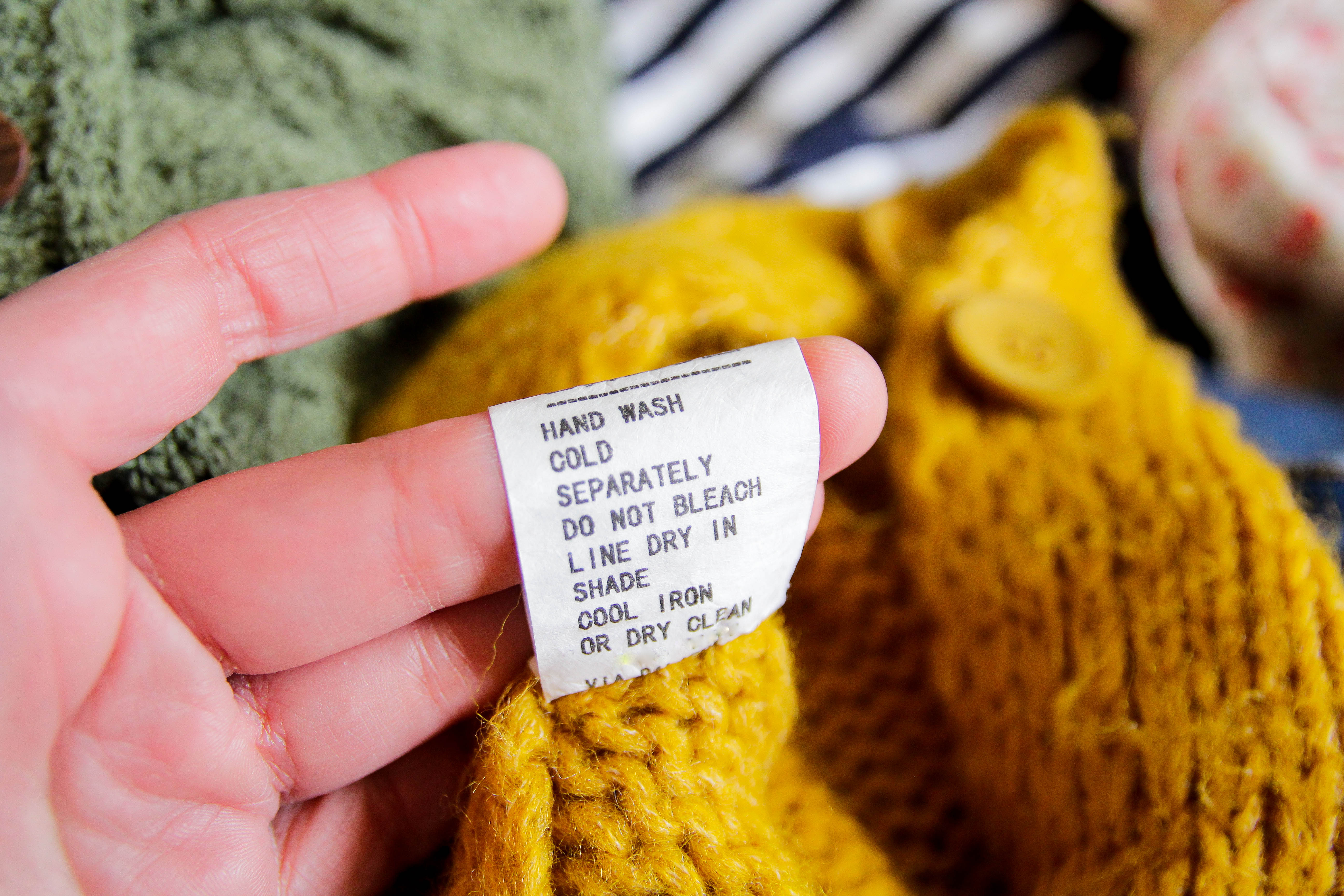 Wash instructions on a knitted sweater | Source: Getty Images