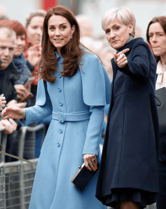 Kate Middleton look on as she is guided by private secretary, Catherine Quinn during a visit CineMagic at the Braid Arts Centre, on February 28, 2019 | Source: Getty Images (Photo by Samir Hussein/Samir Hussein/WireImage)