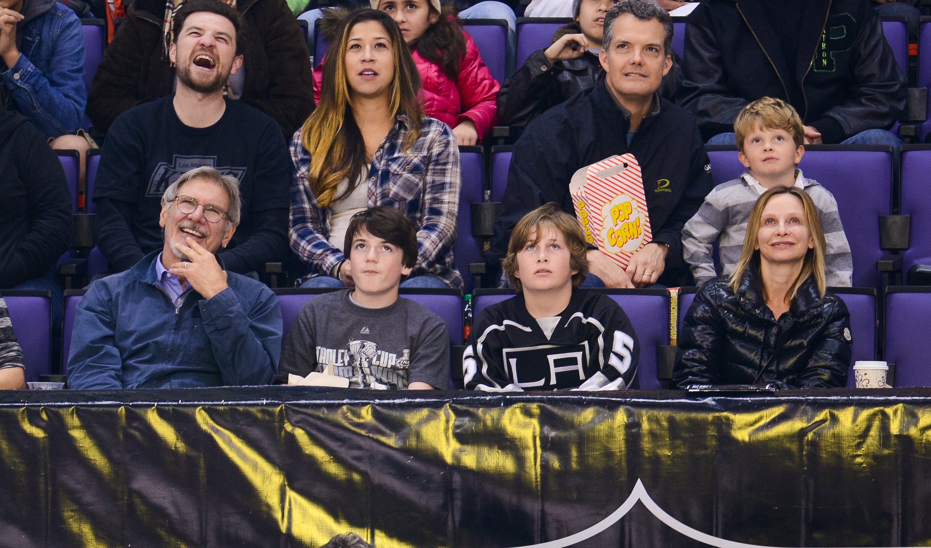 (L-R) Harrison Ford, Liam Flockhart and Calista Flockhart attend a hockey game between the Carolina Hurricanes and the Los Angeles Kings at Staples Center on March 1, 2014 in Los Angeles, California