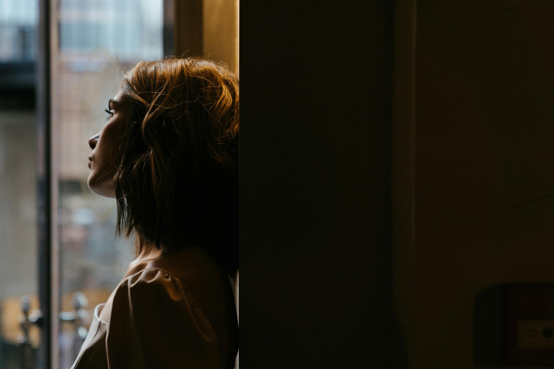 A thoughtful woman looking out the window | Source: Pexels