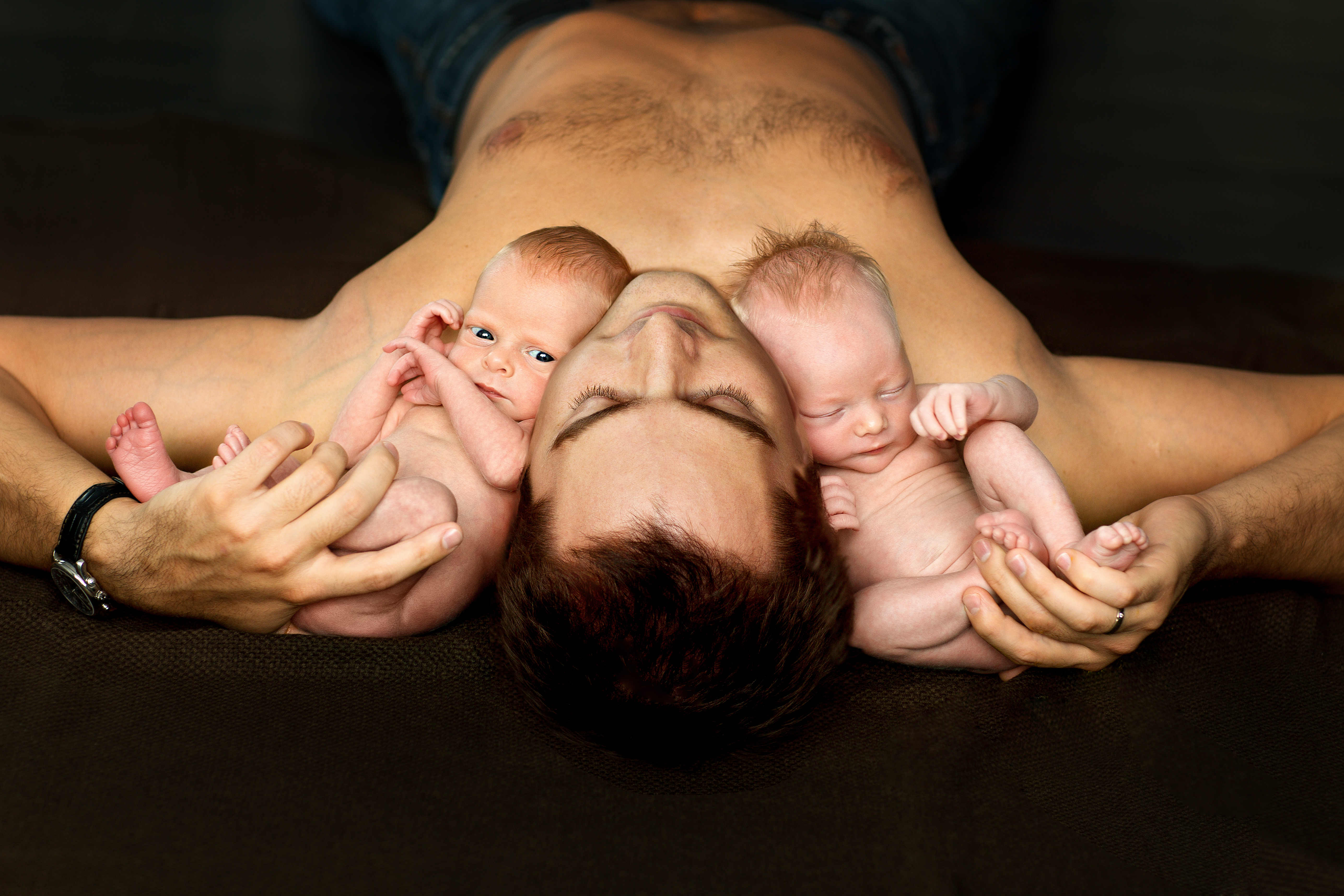 Man with two babies. | Source: Shutterstock