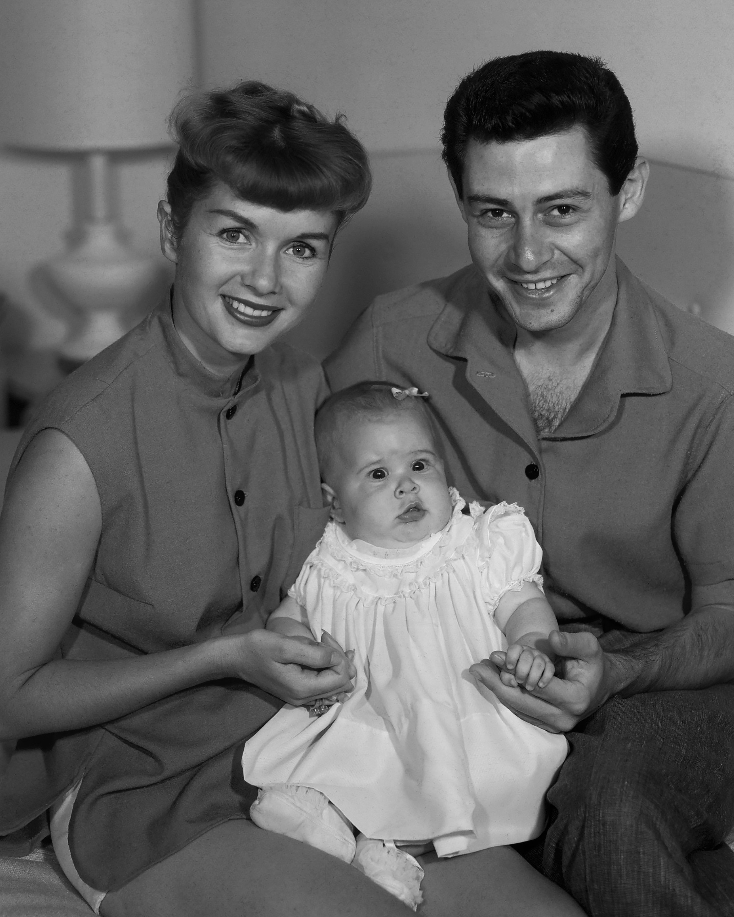 American actress and singer Debbie Reynolds (1932 - 2016) with her husband, singer Eddie Fisher (1928 - 2010) and their baby daughter Carrie Fisher (1956 - 2016), circa 1956 | Source: Getty Images 