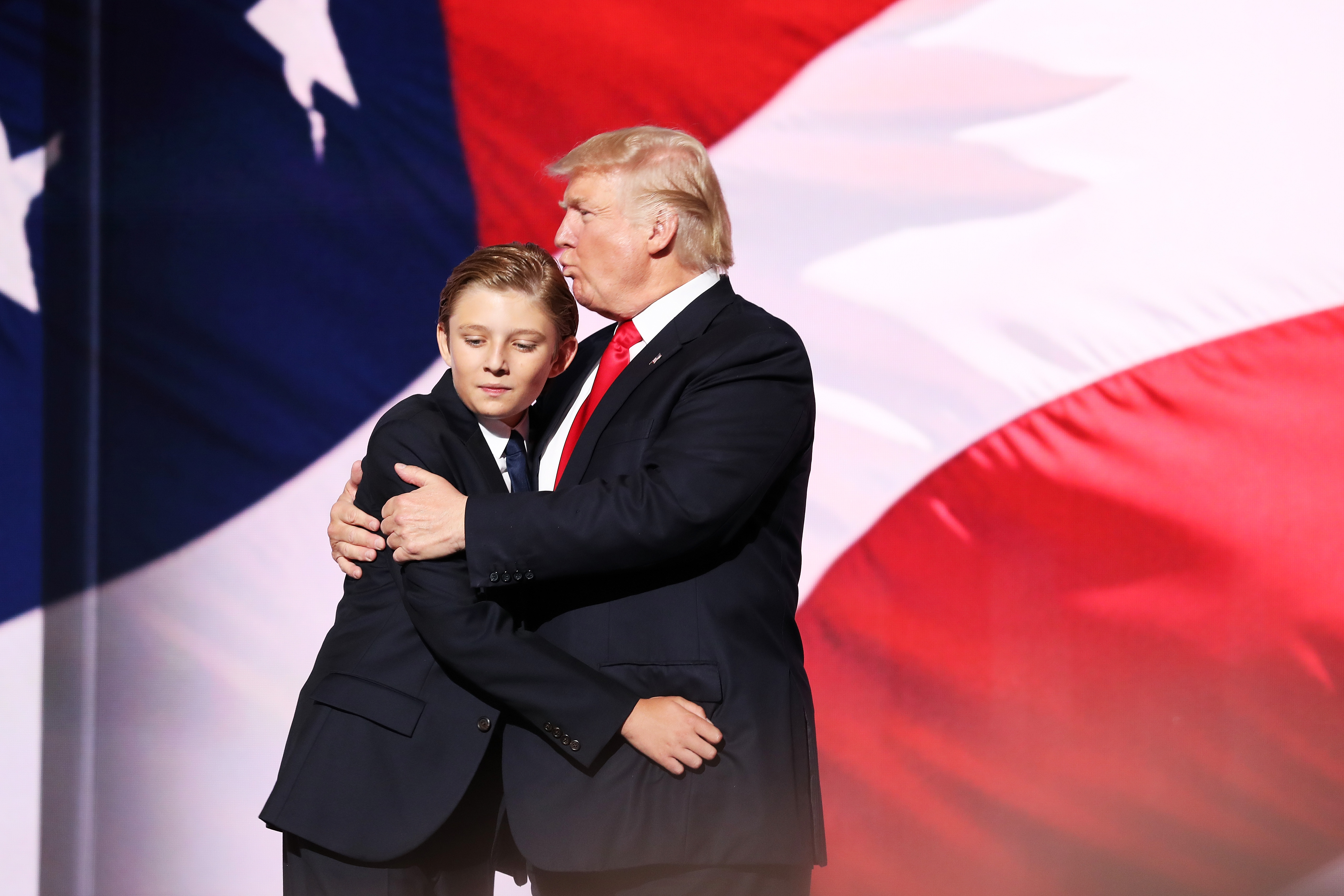Donald embraces Barron Trump after he delivered his speech on the fourth day of the Republican National Convention on July 21, 2016, at the Quicken Loans Arena in Cleveland. | Source: Getty Images