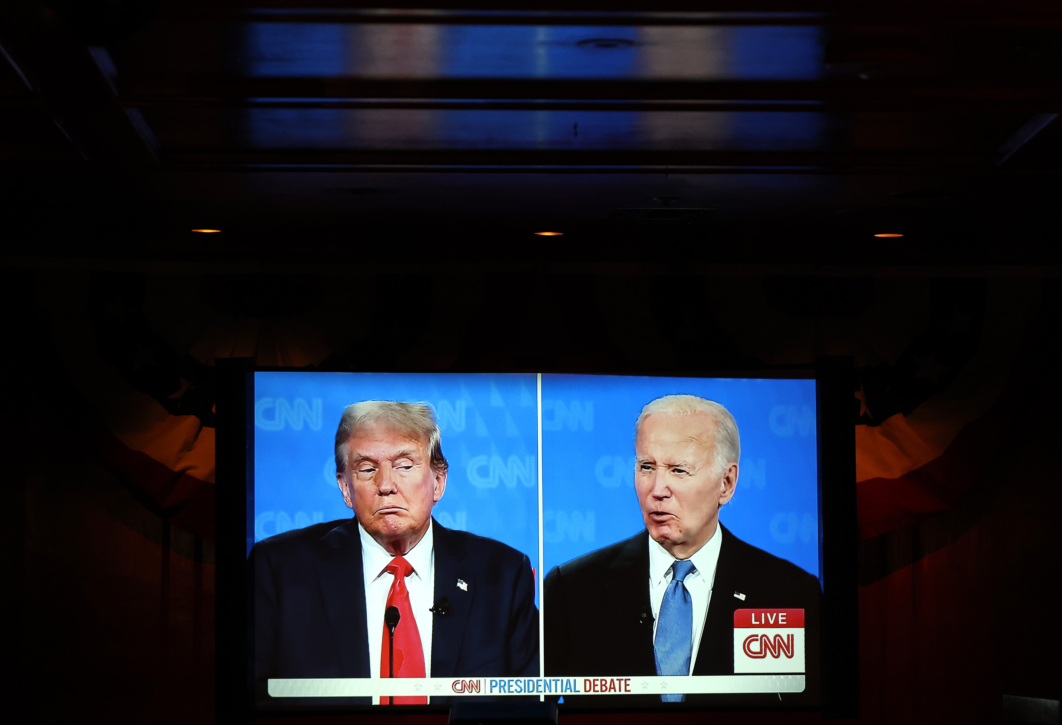 A side-by-side view of US President Donald Trump and former US President Joe Biden on screen during the presidential debate watch party in Los Angeles, California on June 27, 2024. | Source: Getty Images