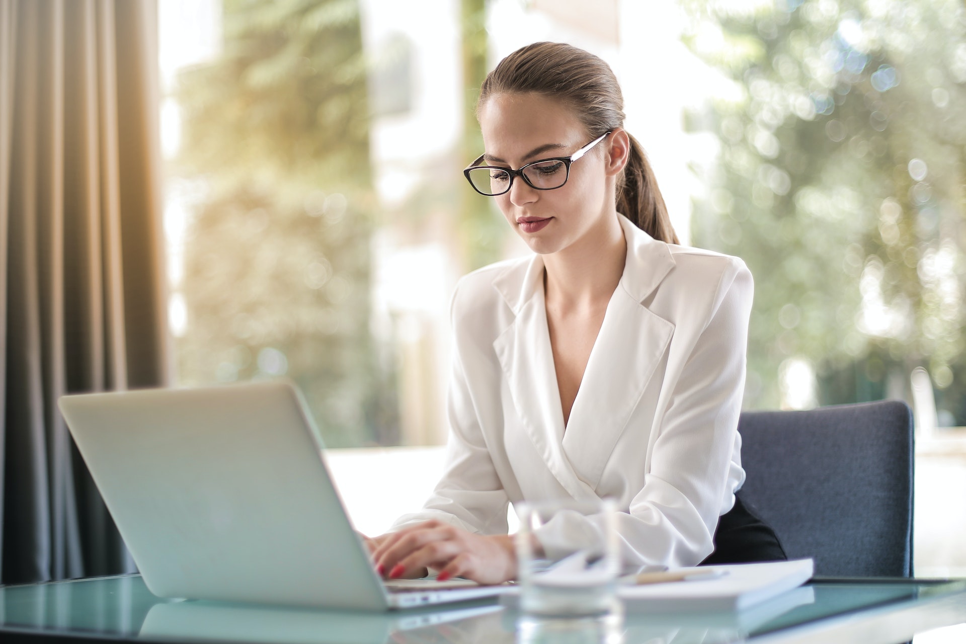 A confident career-oriented woman working on her laptop | Source: Pexels