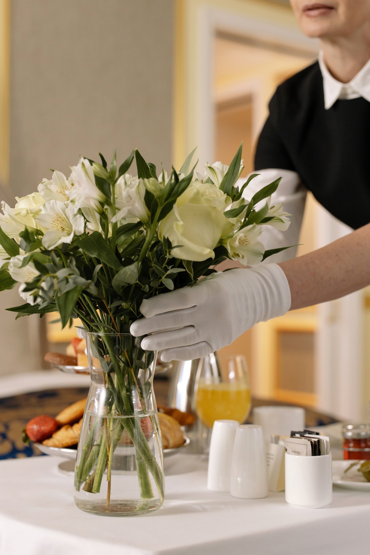 Photo of maid putting a flower in jar | Photo: Pexels