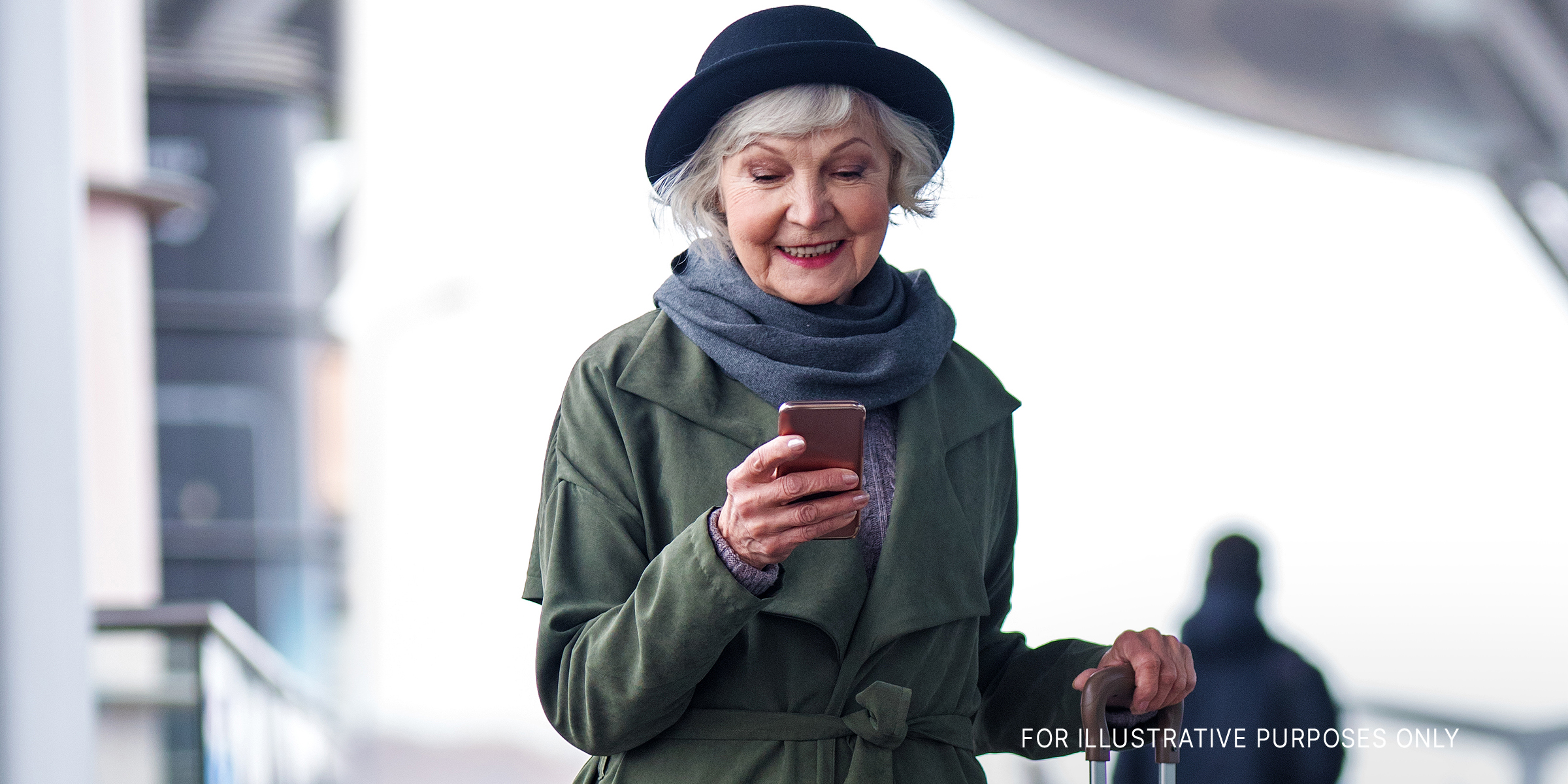 Senior woman on her phone at the airport | Source: Shutterstock