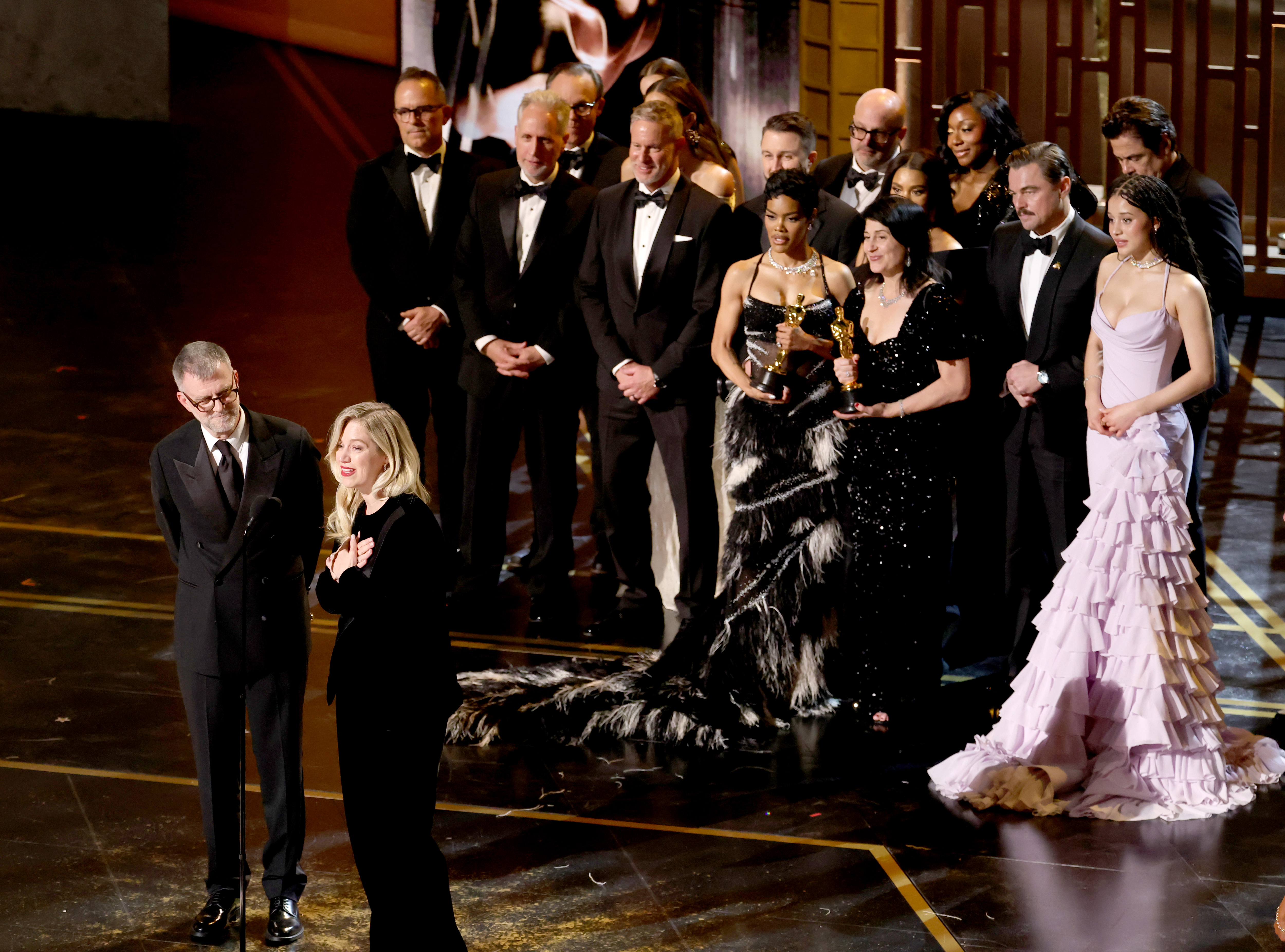 (L-R) Paul Thomas Anderson, Sarah Murphy, Anthony Carlino, Will Weiske, Andy Jurgensen, Teyana Taylor, Michael Bauman, Cassandra Kulukundis, Regina Hall, Shayna McHale aka Junglepussy, Leonardo DiCaprio, Chase Infiniti and Benicio del Toro accept the Best Picture award for "One Battle After Another" onstage during the 98th Oscars at Dolby Theatre on 15 March 2026 in Hollywood, California. | Source: Getty Images