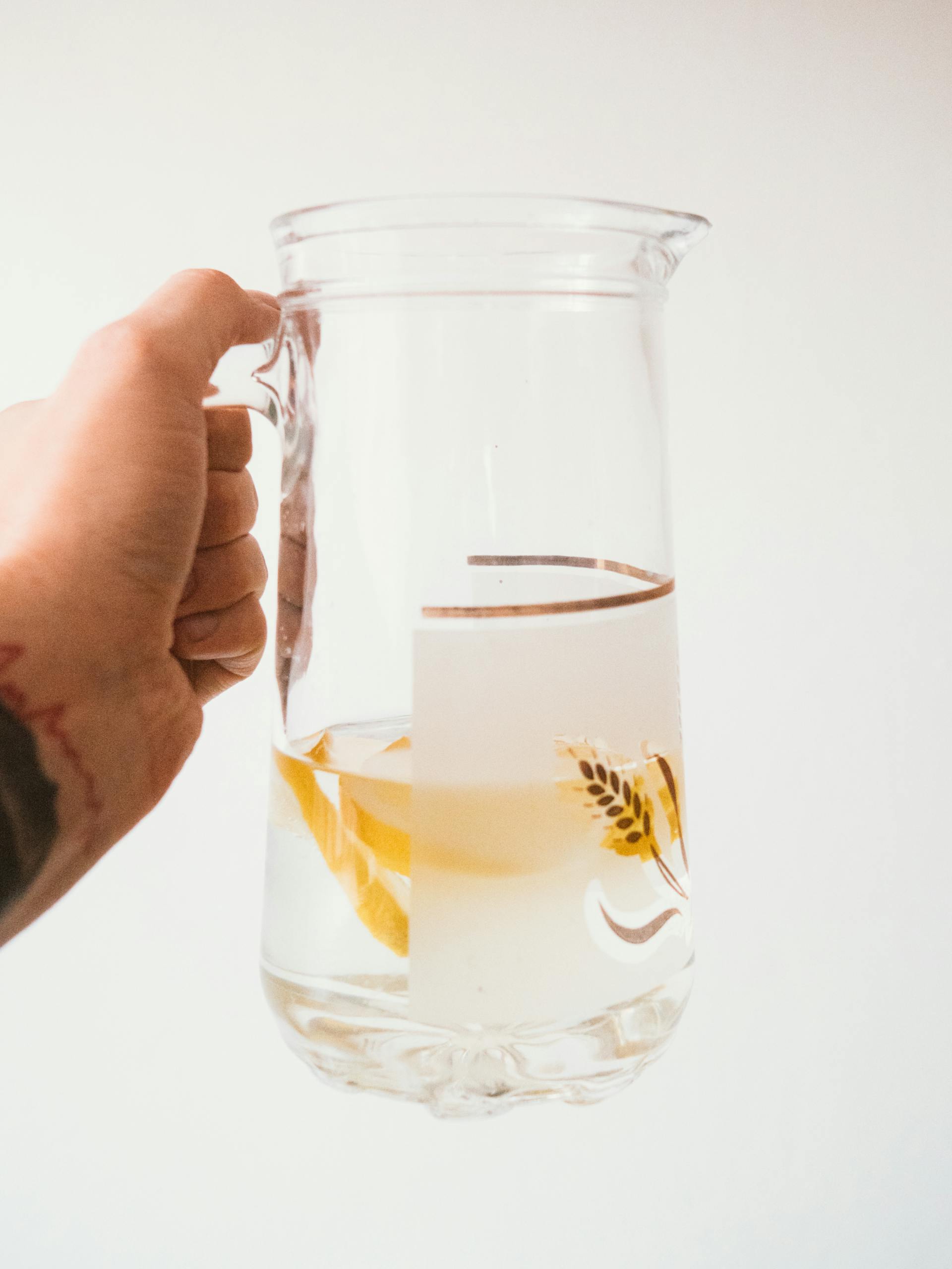 A closeup of a person holding a jug of water | Source: Pexels