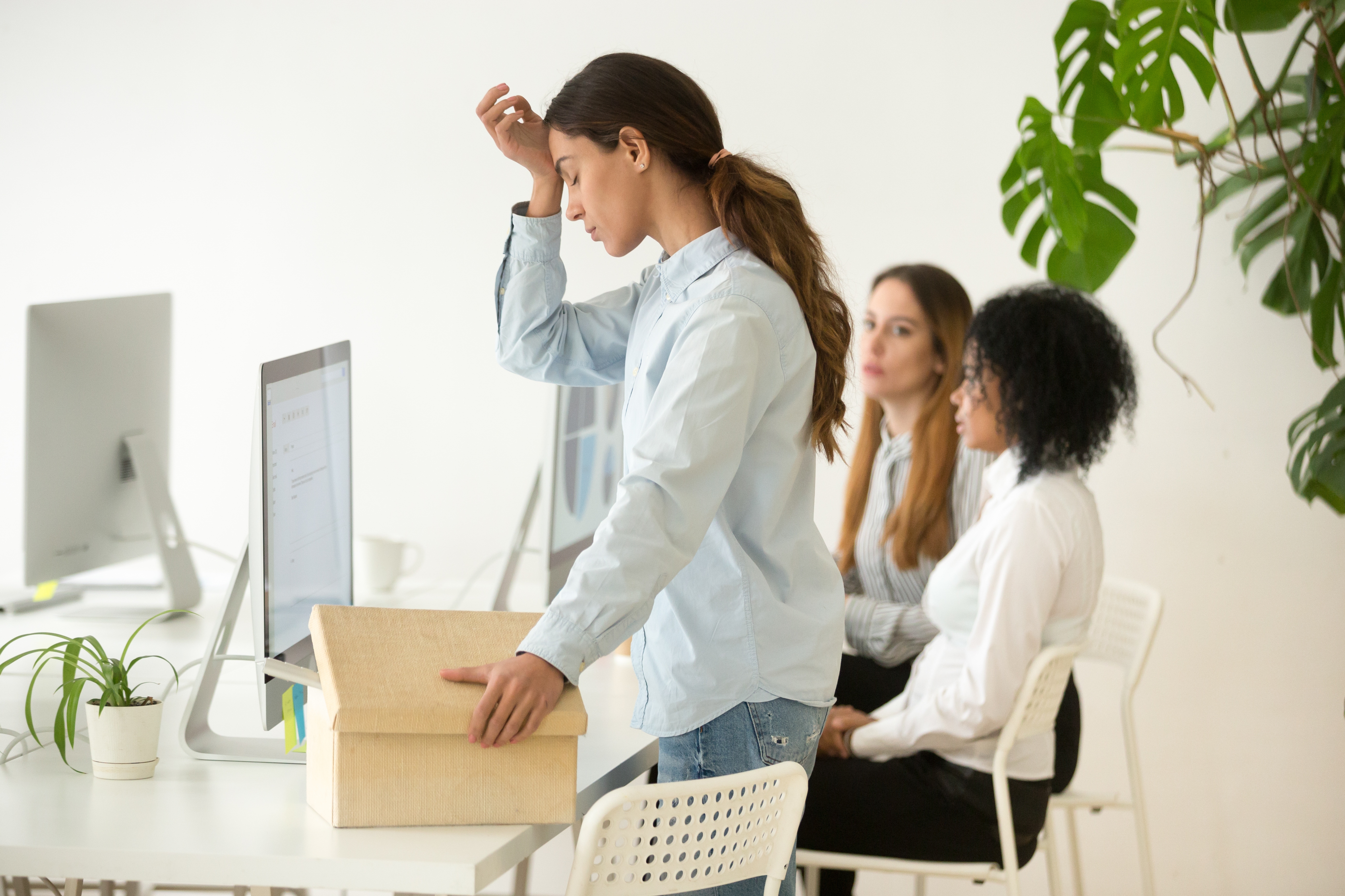Frustrated woman employee preparing to leave after getting fired from job | Source: Shutterstock