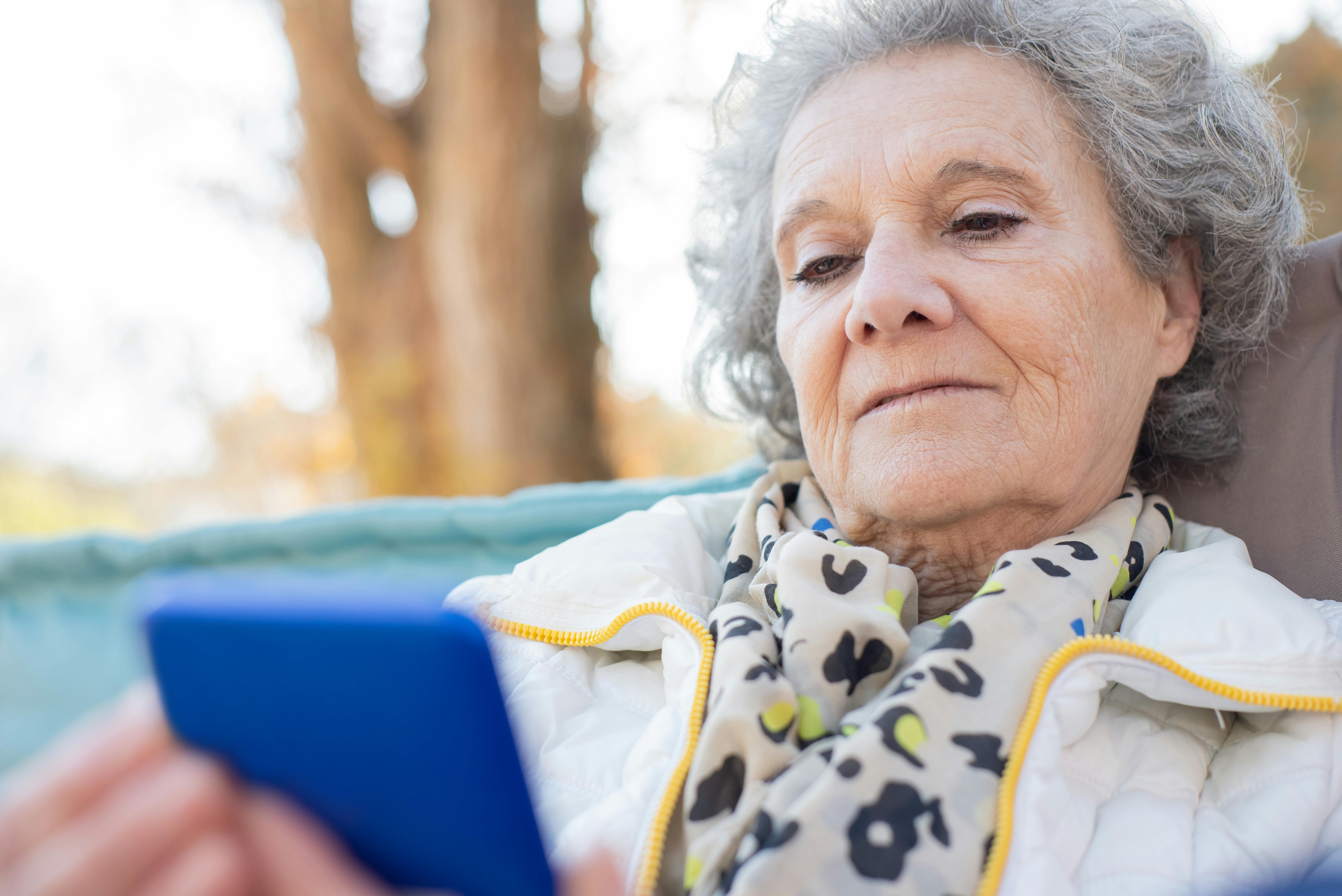 An elderly woman placing a mobile phone call | Source: Pexels