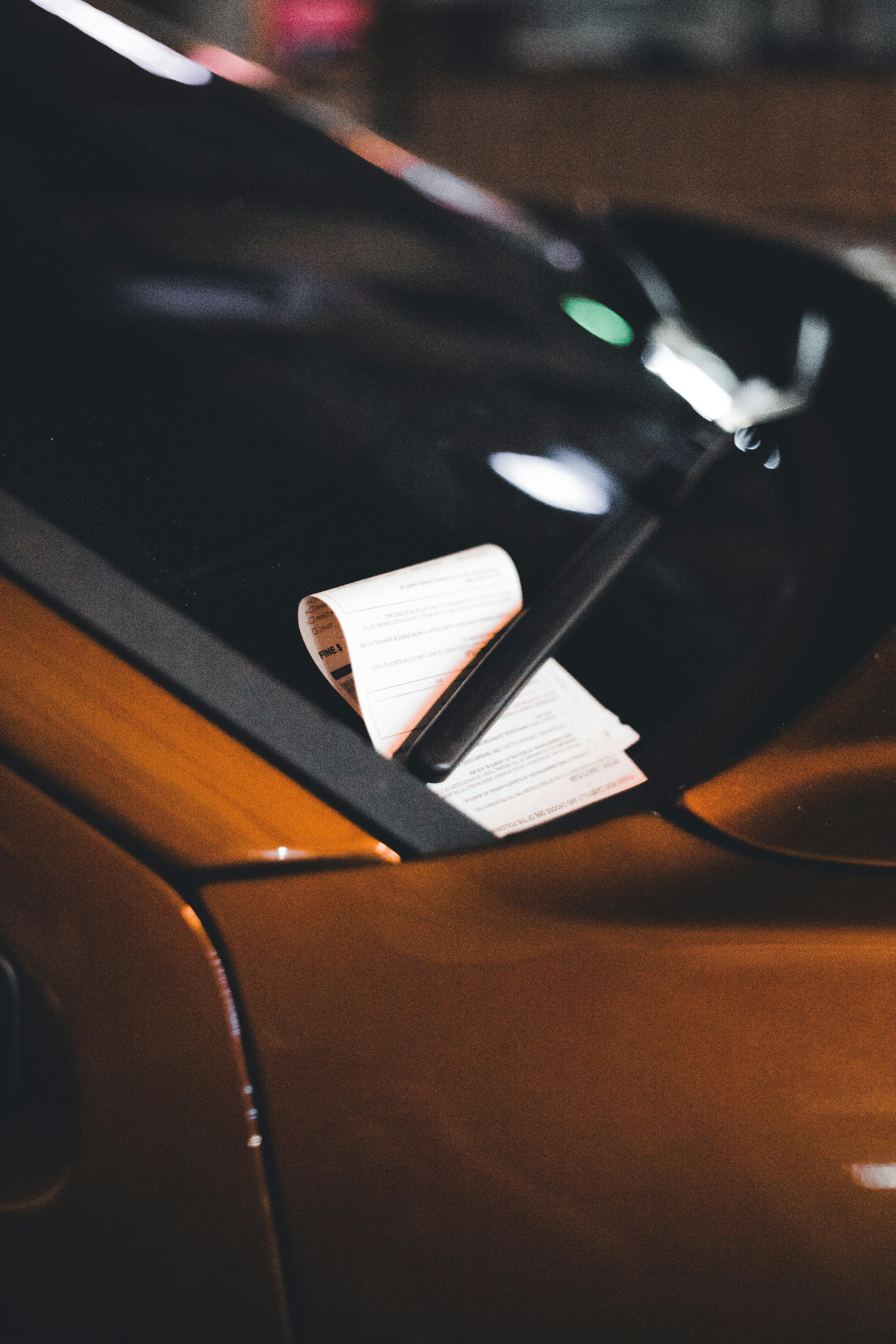 A parking ticket under a windscreen wiper | Source: Pexels