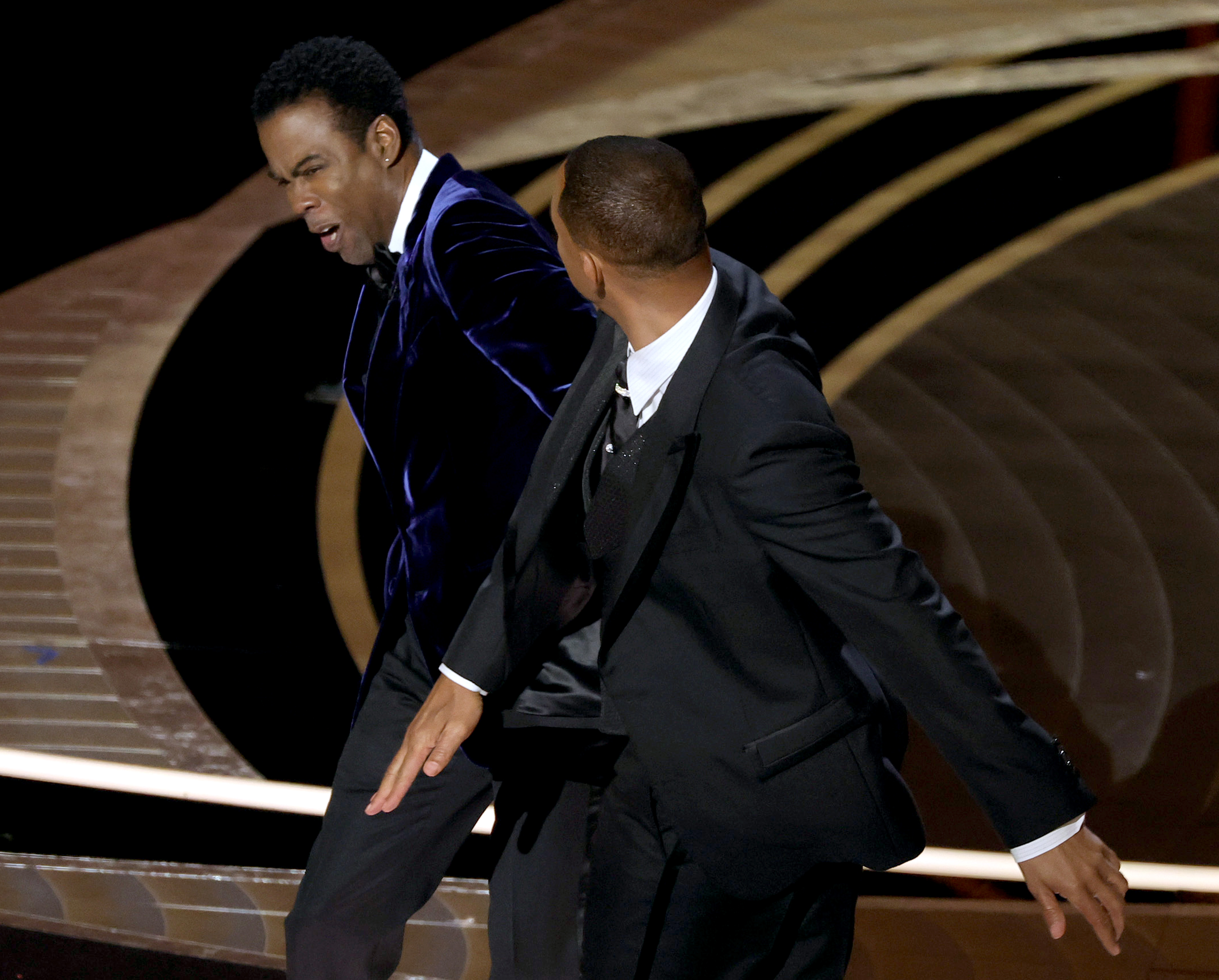 Will Smith appears to slap Chris Rock onstage at the 94th Academy Awards on March 27, 2022 | Source: Getty Images