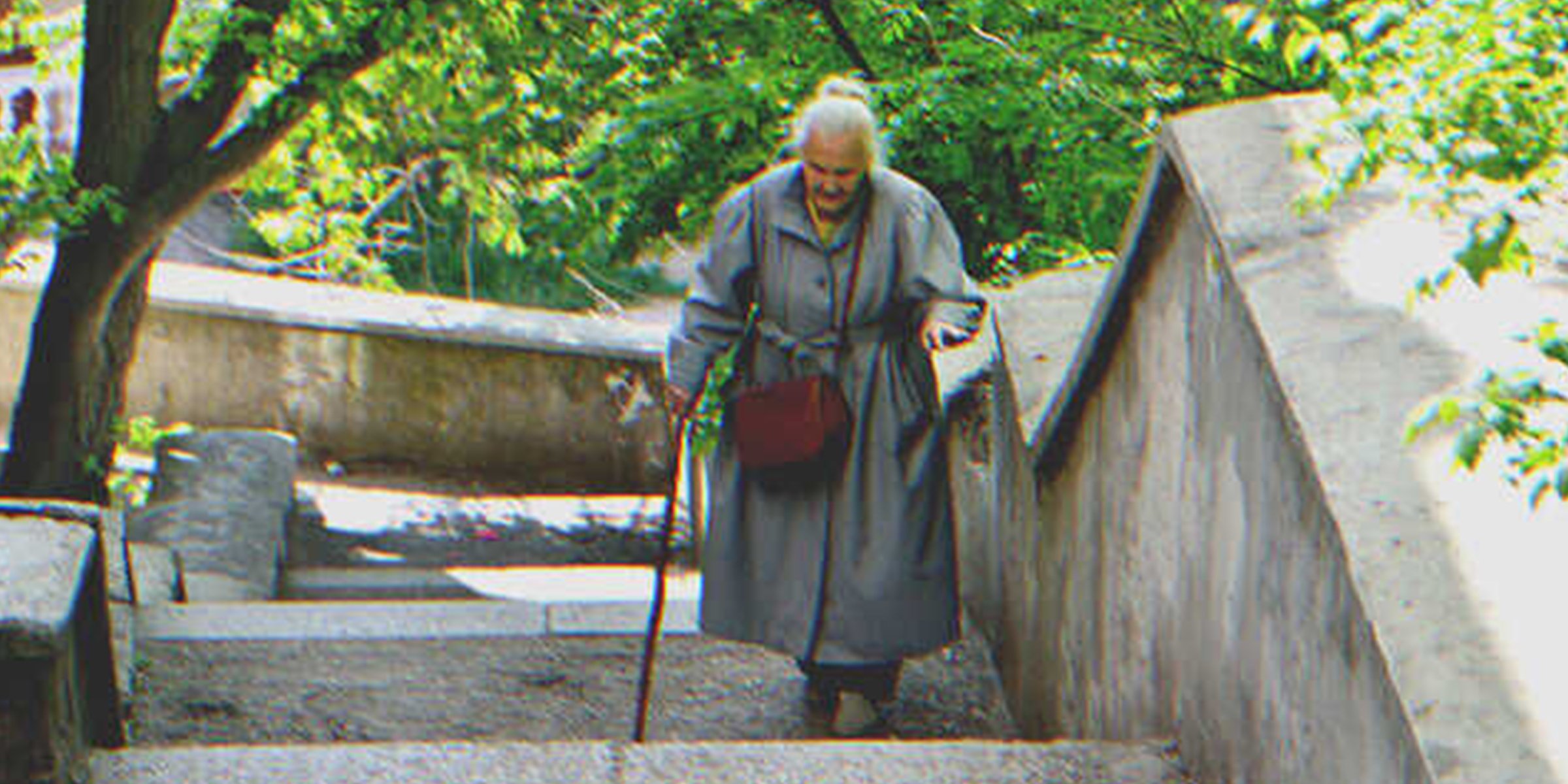 An old lady climbing up a stair | Source: Shutterstock