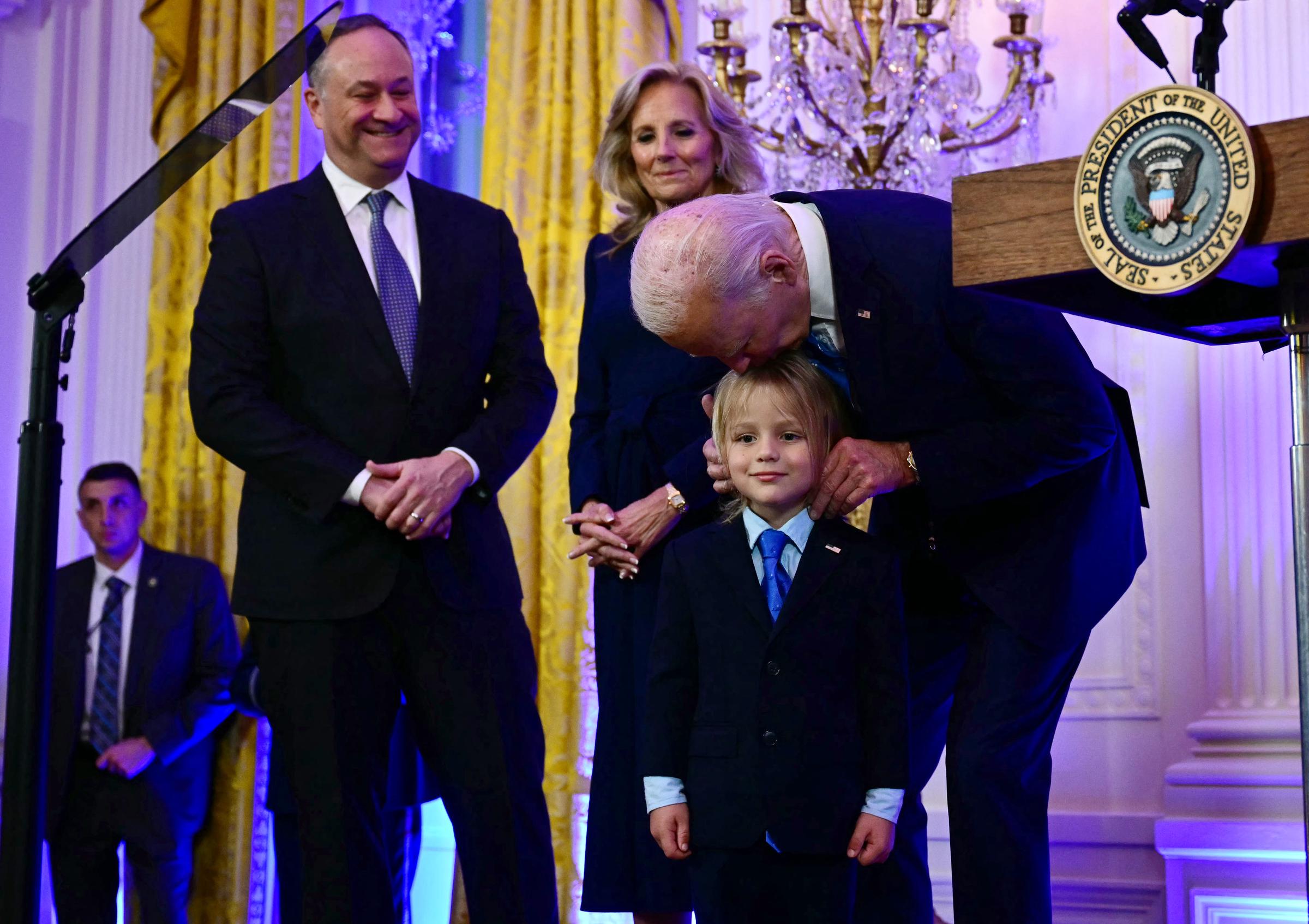 US Second Gentleman Doug Emhoff and First Lady Jill Biden watch as President Joe Biden speaks with Beau Biden Jr. during a Hanukkah holiday reception at the White House on December 16, 2024, in Washington, D.C. | Source: Getty Images