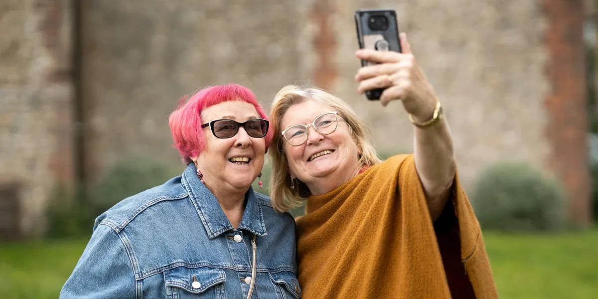 Two friends taking a photo together | Source: Pexels