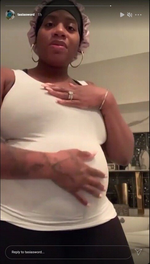 Screenshot of video of Fantasia Barrino cradling her baby bump. | Source: Instagram/tasiasword
