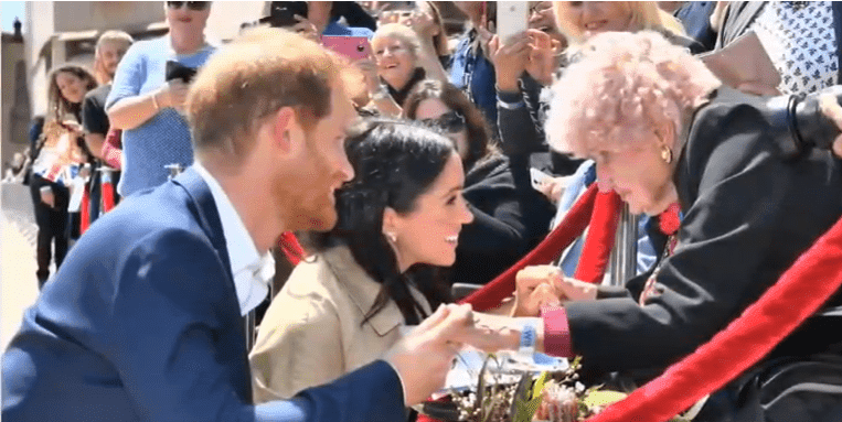 Prince Harry introducing Daphne Dunne to Meghan Markle.| Photo: YouTube/ Royal Fashion Az