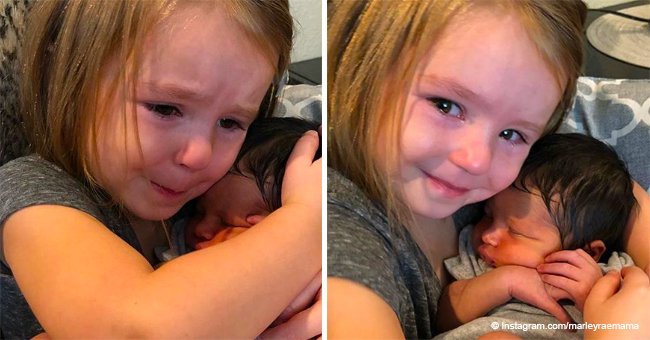 Little girl cuddles newborn cousin for the first time, and her adorable reaction goes viral