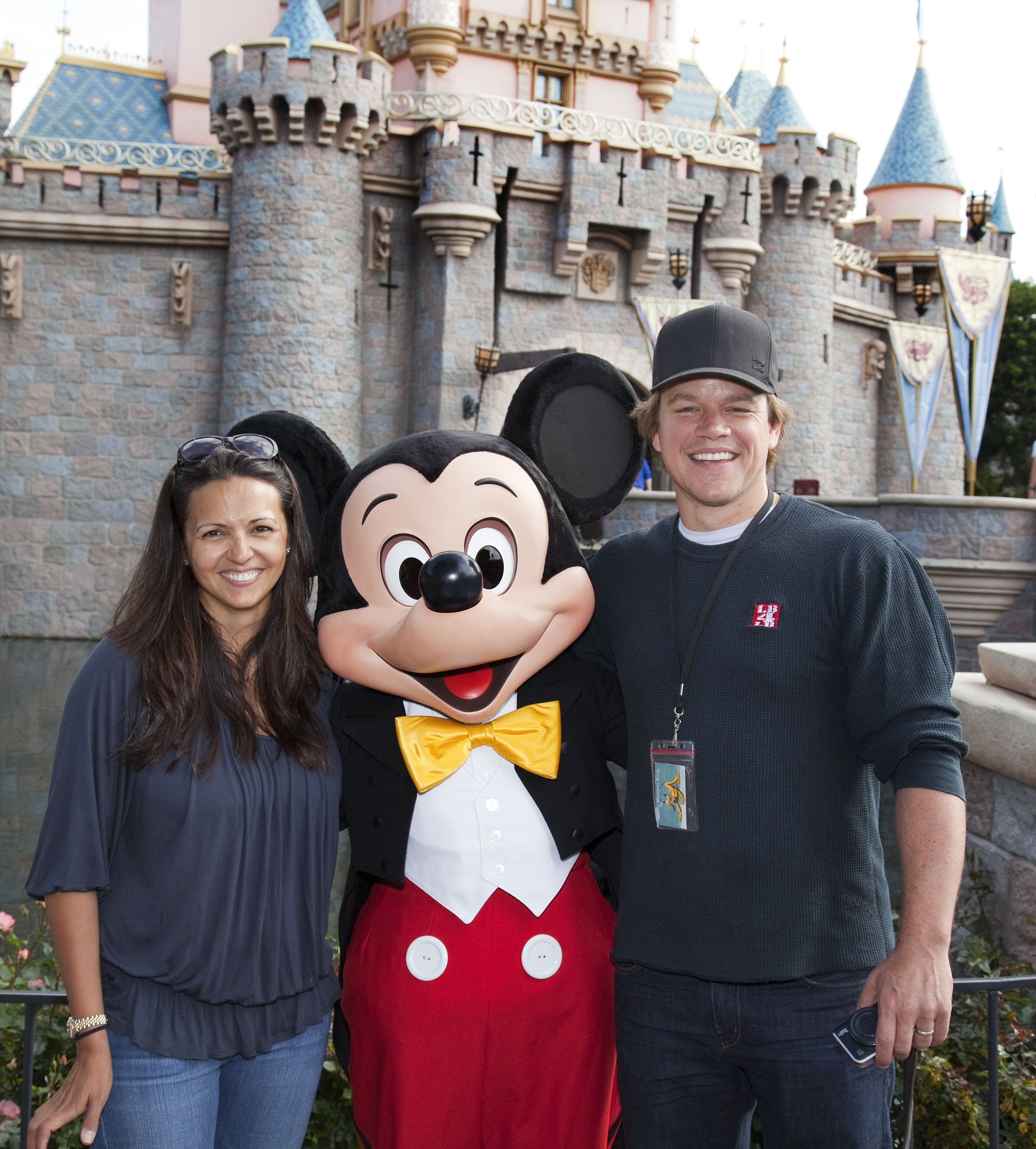 Matt Damon and his wife Luciana pose with Mickey Mouse at Sleeping Beauty Castle at Disneyland April 22, 2011 in Anaheim, California | Source: Getty Images 
