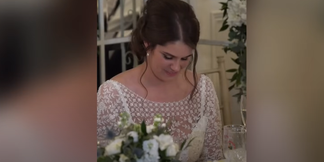 Katie smiles as she looks down during her husband's wedding speech | Source: YouTube / Daily Record