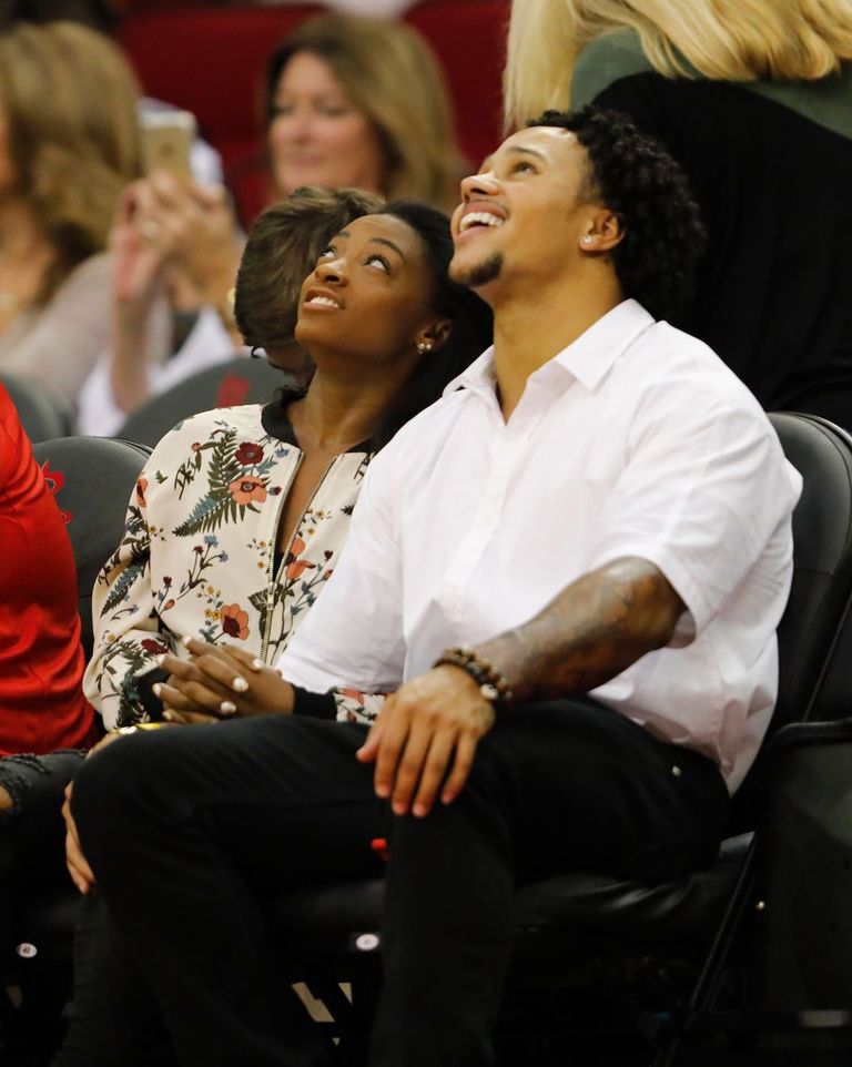 Simone Biles and Stacey Ervin watch the game between the Houston Rockets and the Utah Jazz in November 2017 | Photo: Getty Images