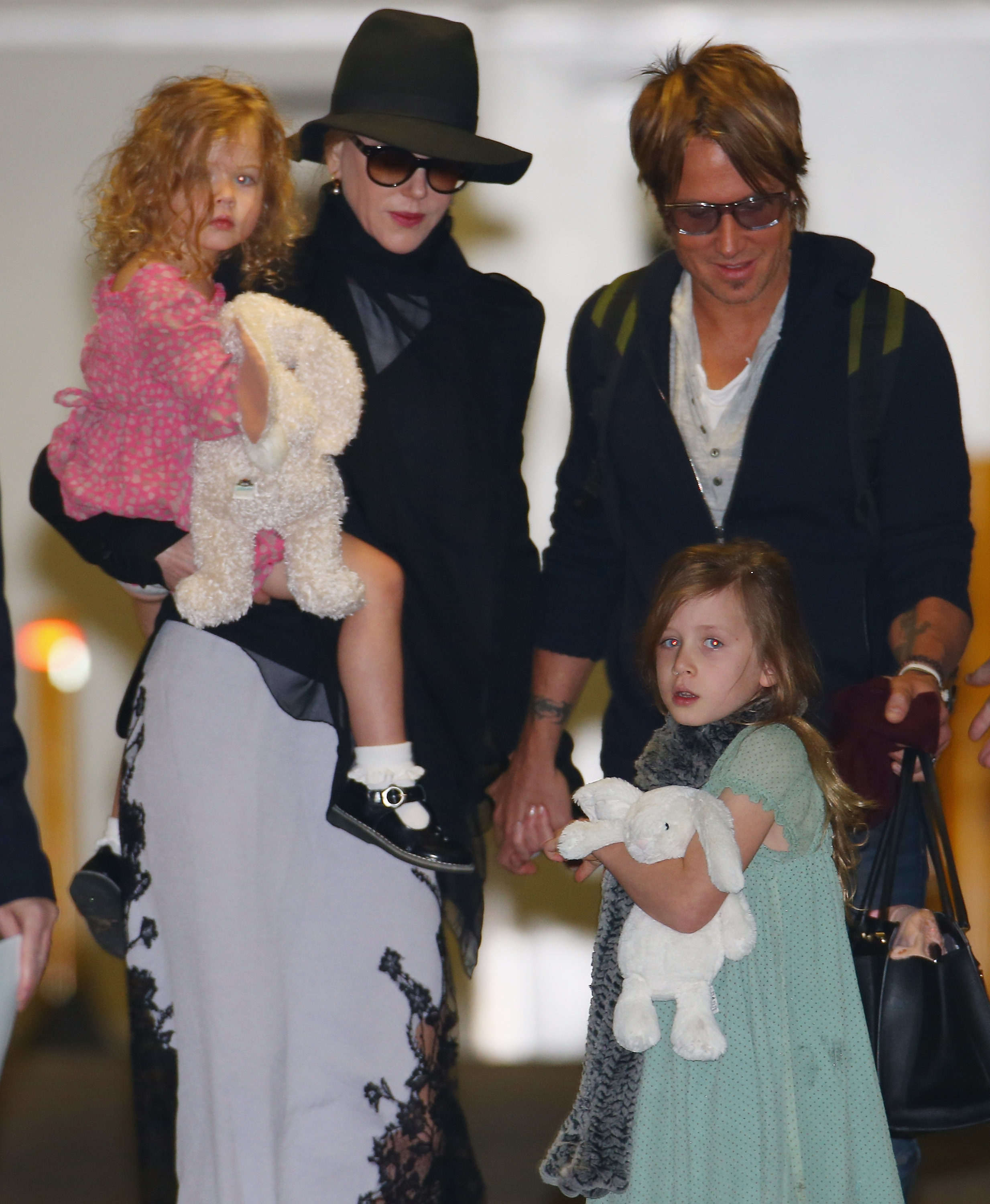 Nicole Kidman and Keith Urban with their daughters, Faith and Sunday Rose Kidman Urban, at Sydney International Airport on June 11, 2014, in Australia. | Source: Getty Images