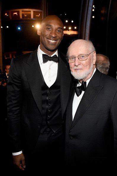 Kobe Bryant and John Williams posing in the audience during American Film Institutes 44th Life Achievement Award Gala | Photo:Getty Images