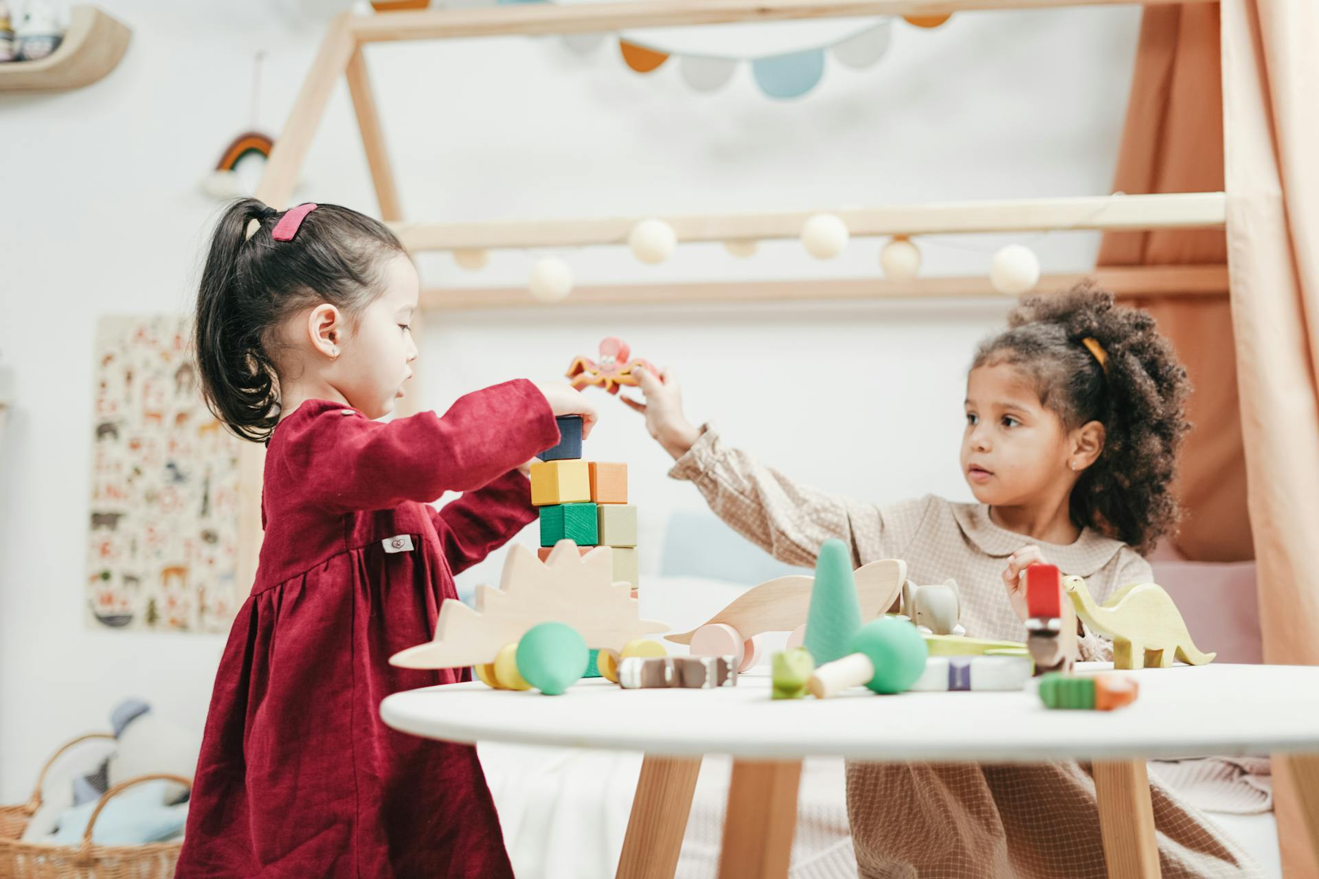 Children playing with wooden blocks | Source: Pexels