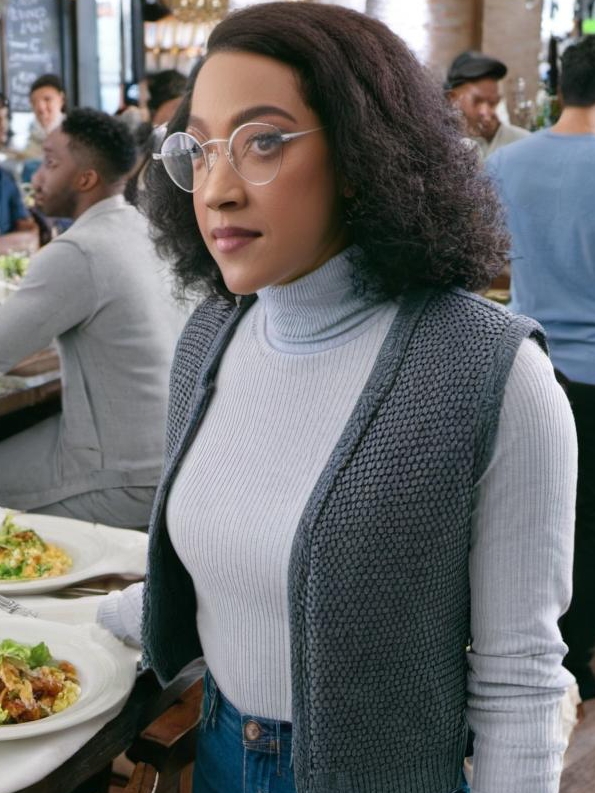 A woman standing in a crowded restaurant | Source: Midjourney