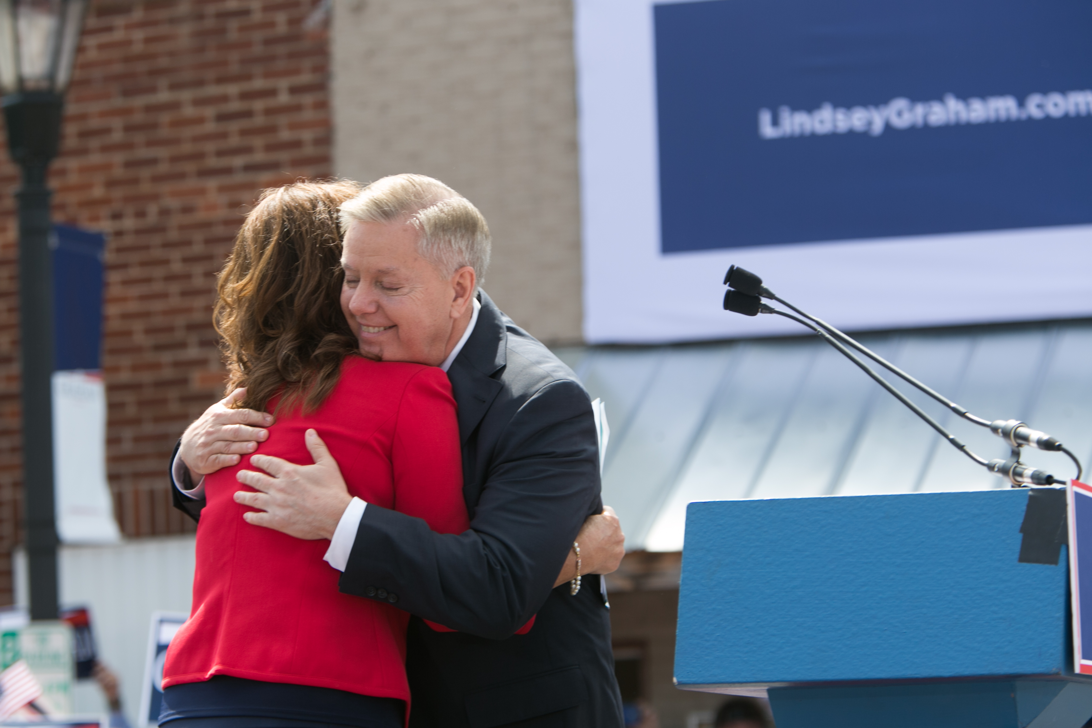 Lindsey Graham and Darline Graham Nordone share a moment during his 2015 presidential campaign announcement. Years before her appointment, Graham had already spoken about the trust and confidence he had in his sister. | Source: Getty Images