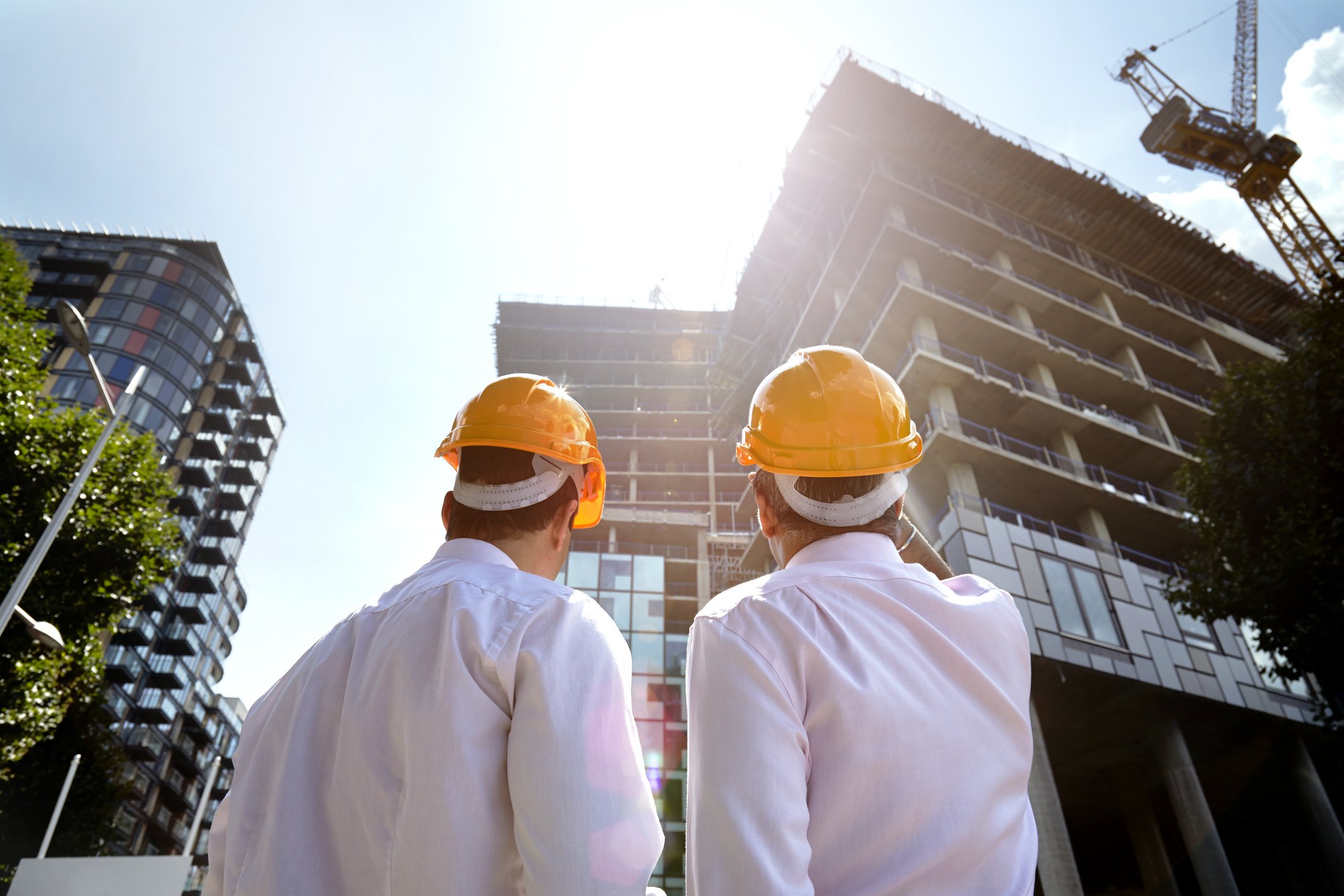 Two architects looking up at development building. | Photo: Getty Images