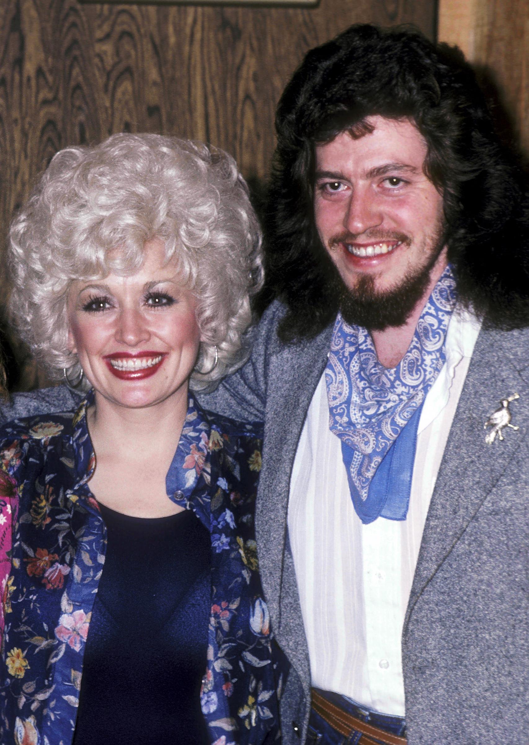 Dolly Parton poses with her brother Floyd Parton in 1981. Floyd, a songwriter who collaborated with his sister during his career, died in 2018 at age 61. | Source: Getty Images