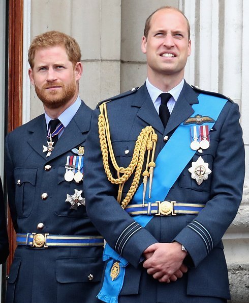 Prince William, Duke of Cambridge and Prince Harry, Duke of Sussex watch the RAF flypast on the balcony of Buckingham Palace, as members of the Royal Family attend events to mark the centenary of the RAF on July 10, 2018 in London, England | Photo: Getty Images