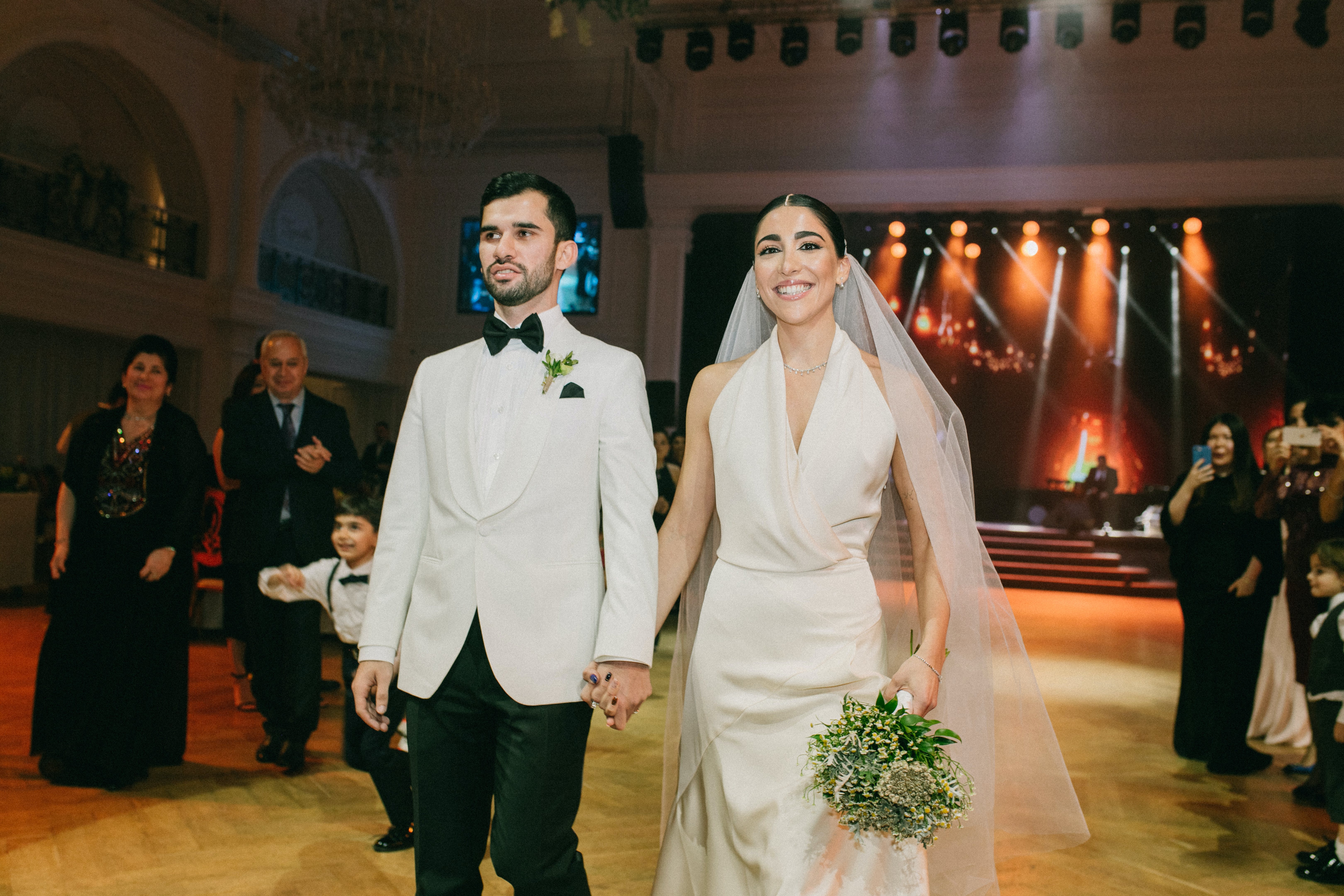 The groom and bride walking hand in hand at wedding venue | Source: Pexels