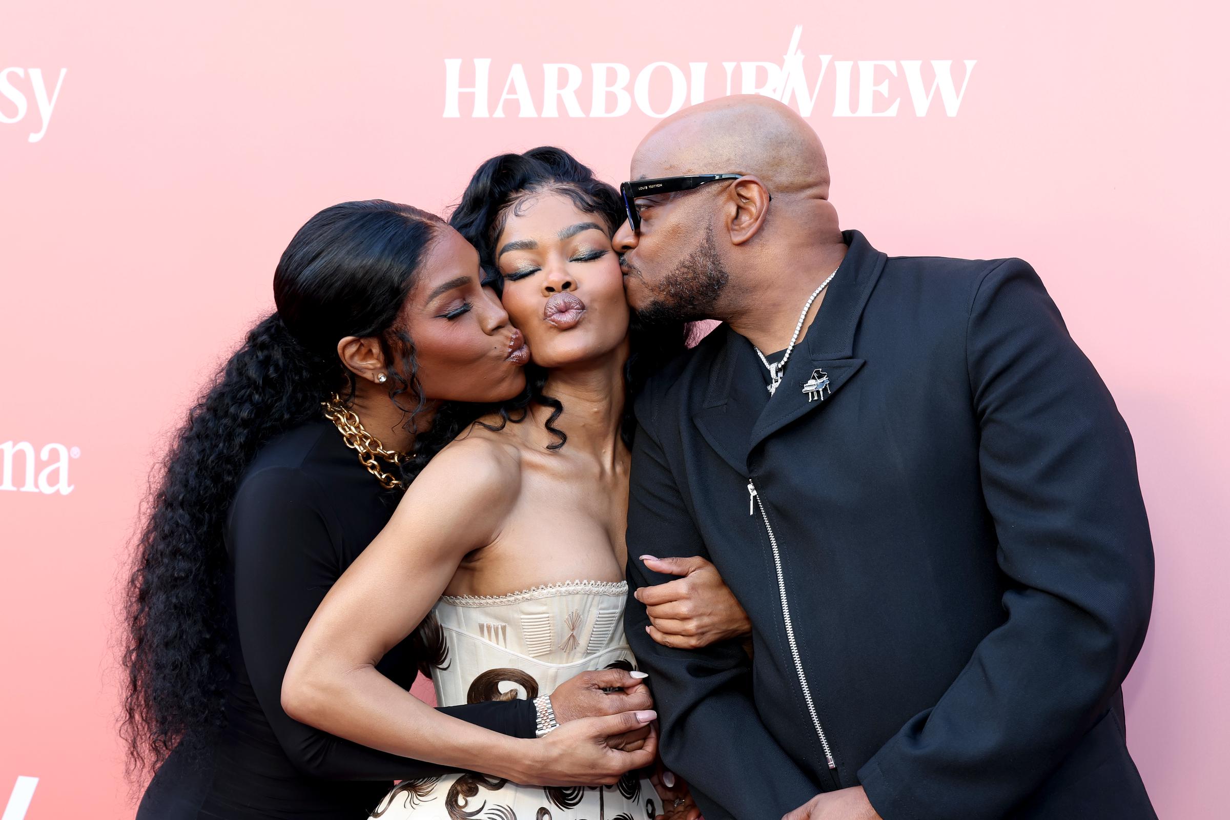 Teyana Taylor puckers up as Nikki Taylor and Boe Daney lean in from both sides, sharing a playful double kiss moment | Source: Getty Images