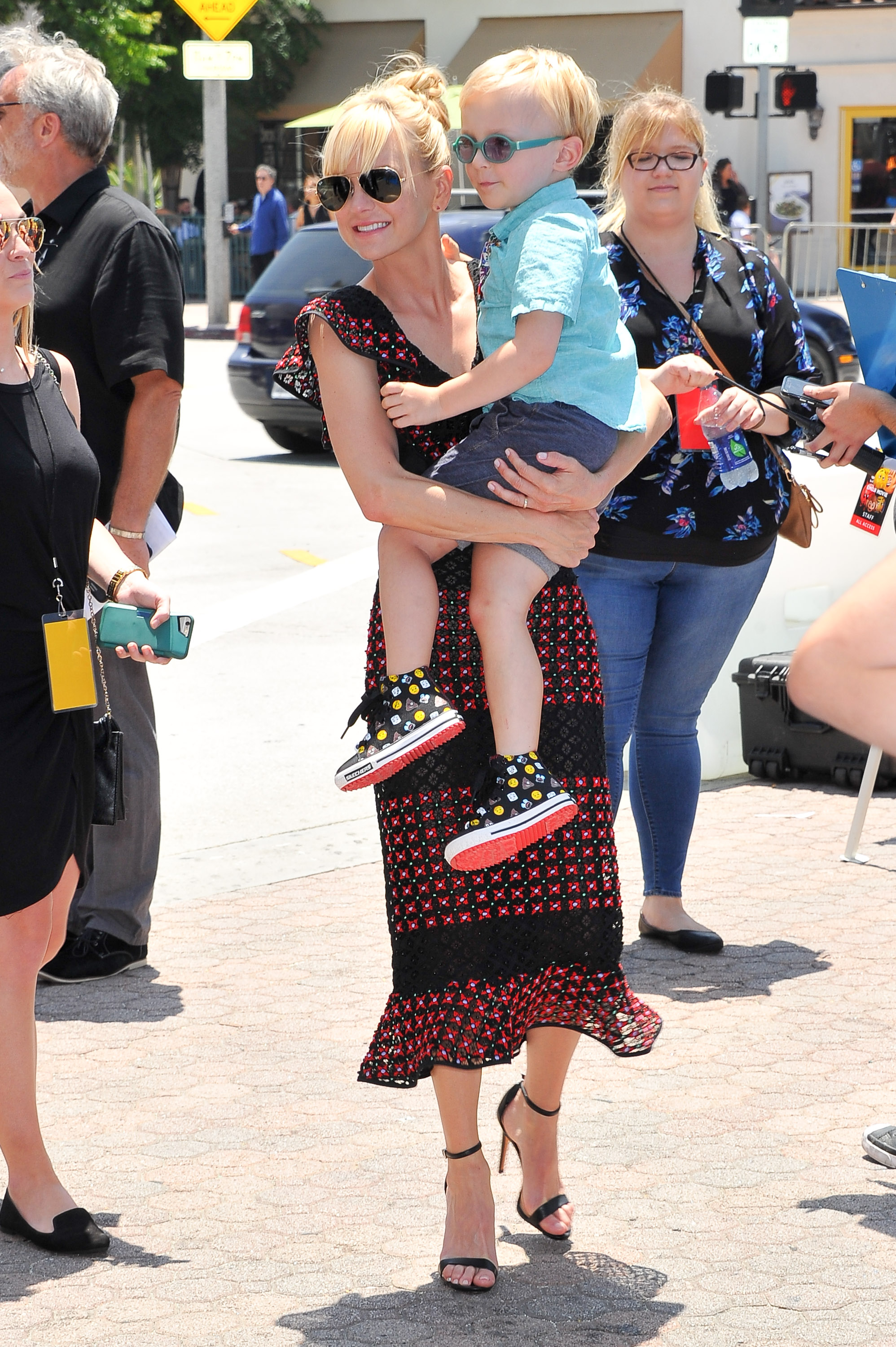 Anna Faris carries son Jack Pratt while attending the premiere of Columbia Pictures and Sony Pictures Animation's "The Emoji Movie." The pair shared a sweet moment as they made their way through the event, with Jack sporting colorful glasses and a bright smile.