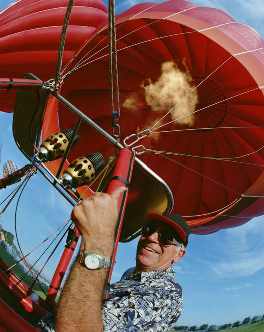 Foto eines erwachsenen Mannes, der im Heißluftballon den Daumen nach oben streckt | Quelle: Getty Images 