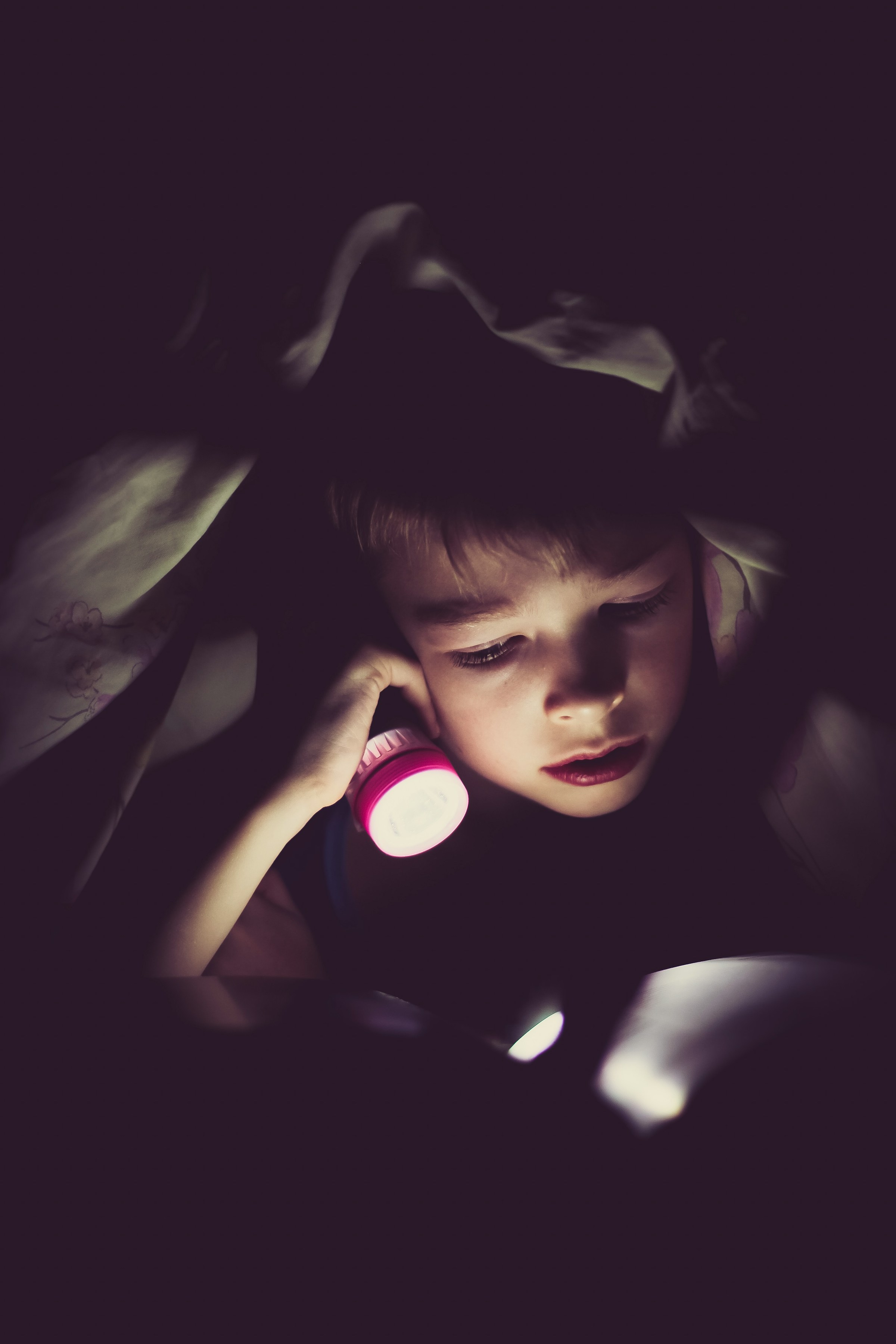 A little boy holding a flashlight | Source: Unsplash