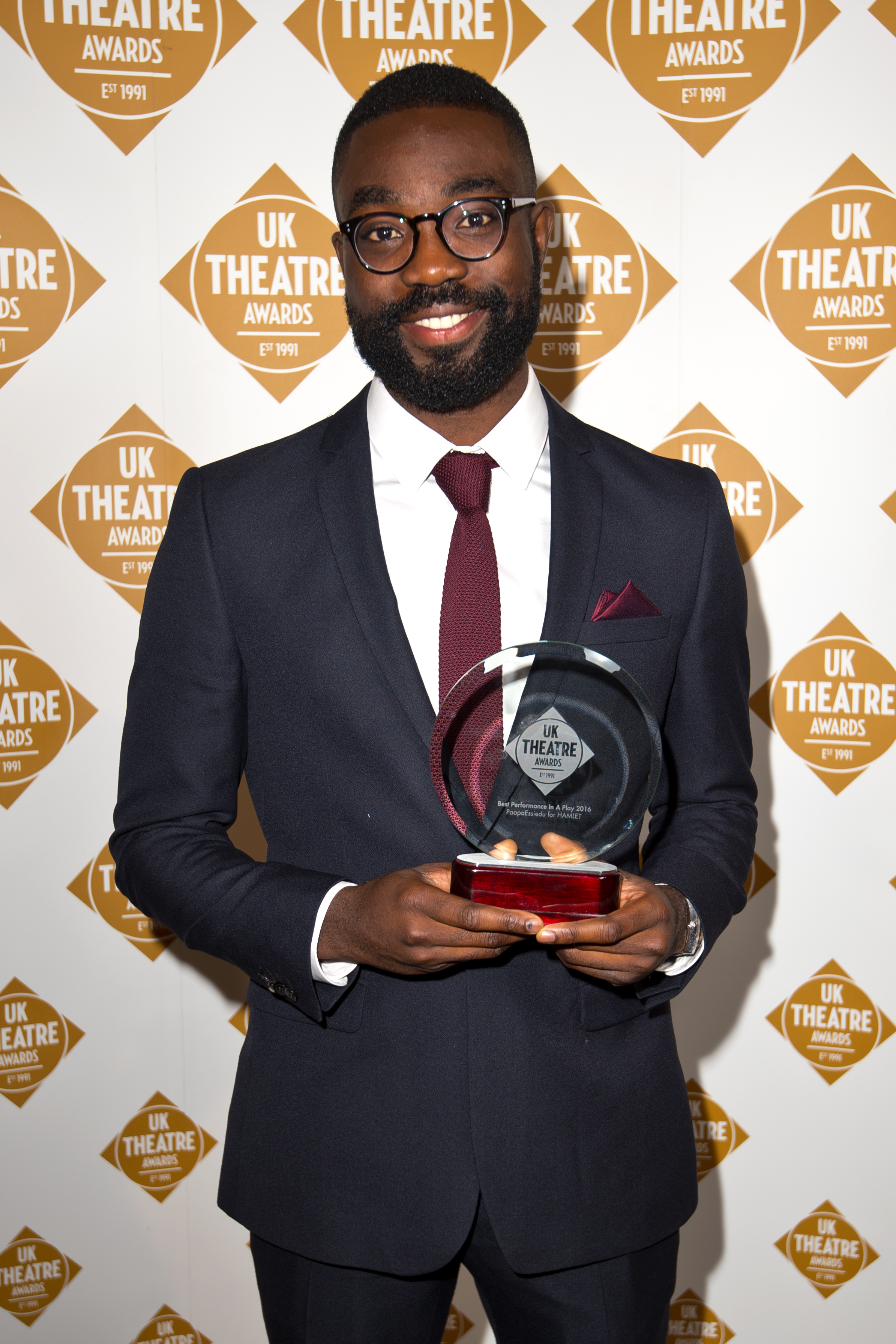Paapa Essiedu poses with his award for best performance in a play for "Hamlet" at the UK Theatre Awards at The Guildhall on October 9, 2016, in London, England | Source: Getty Images