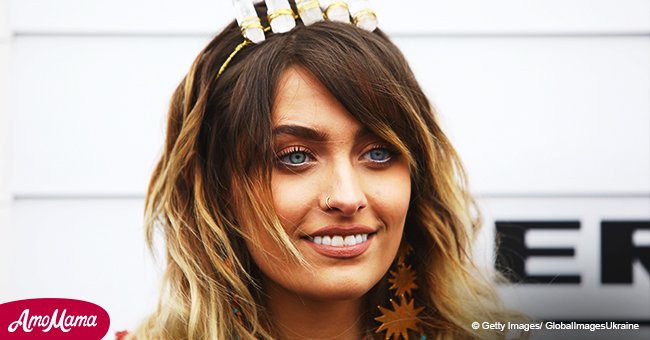 Paris Jackson wears a crown while displaying tattoos in a stylish gown at a recent red carpet