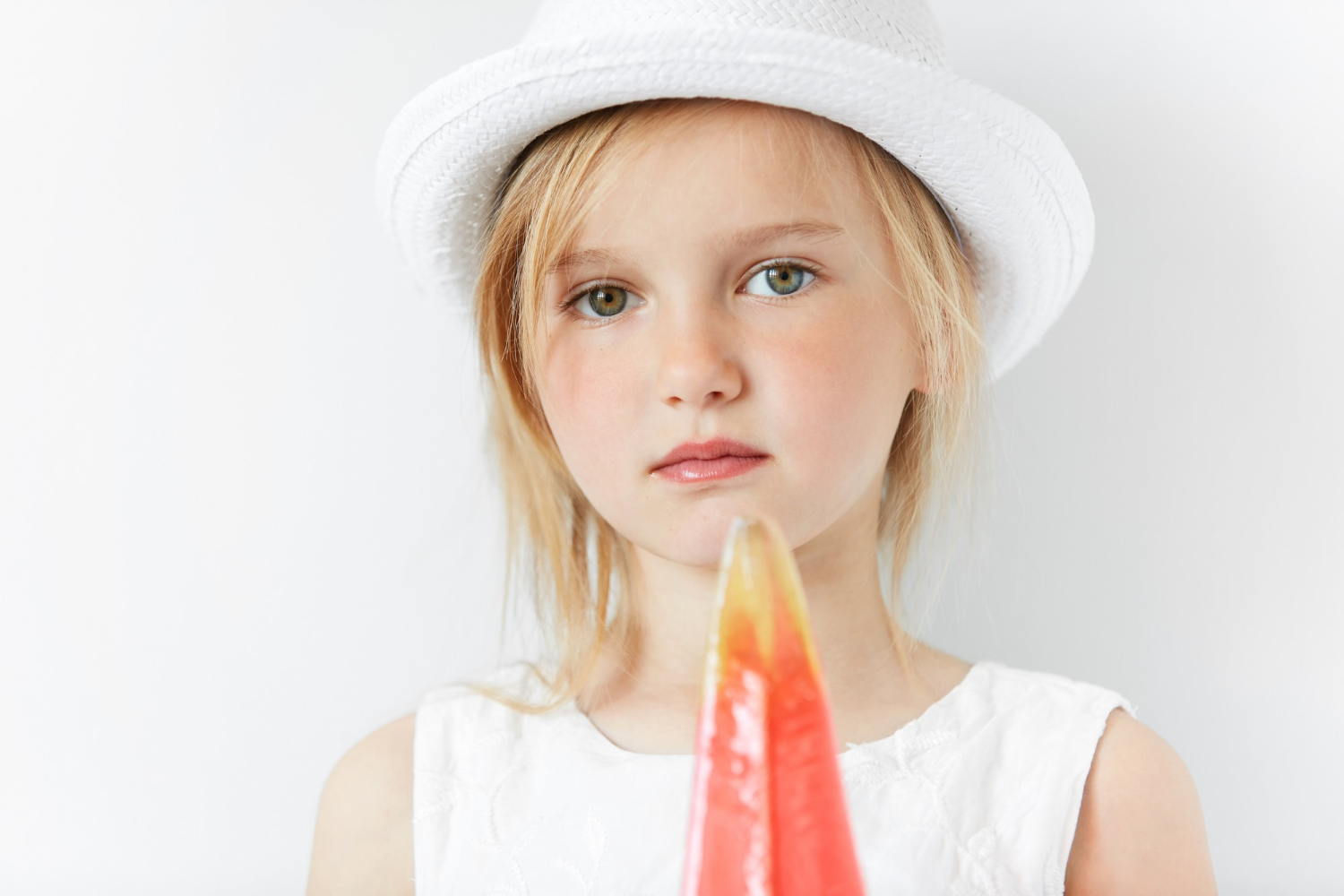 A young girl holding a popsicle | Source: Freepik