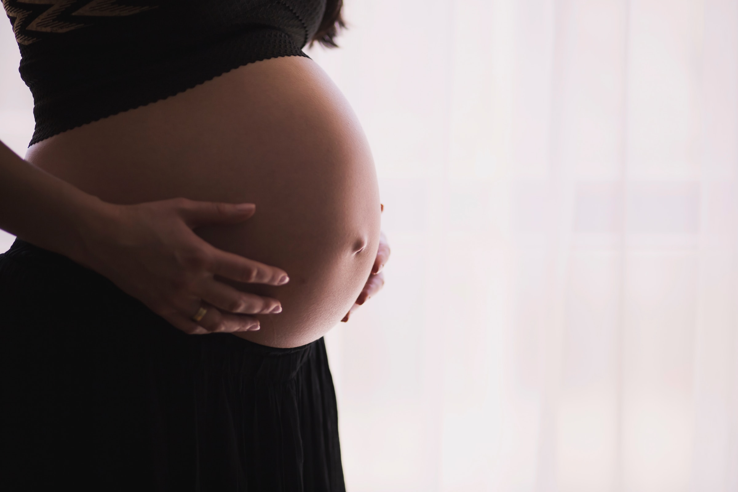 Pregnant woman holding her belly | Source: Unsplash