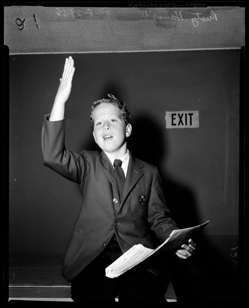 A portrait of Rusty Hamer holding a document in his hand on January 01, 1958 | Photo: Getty Images