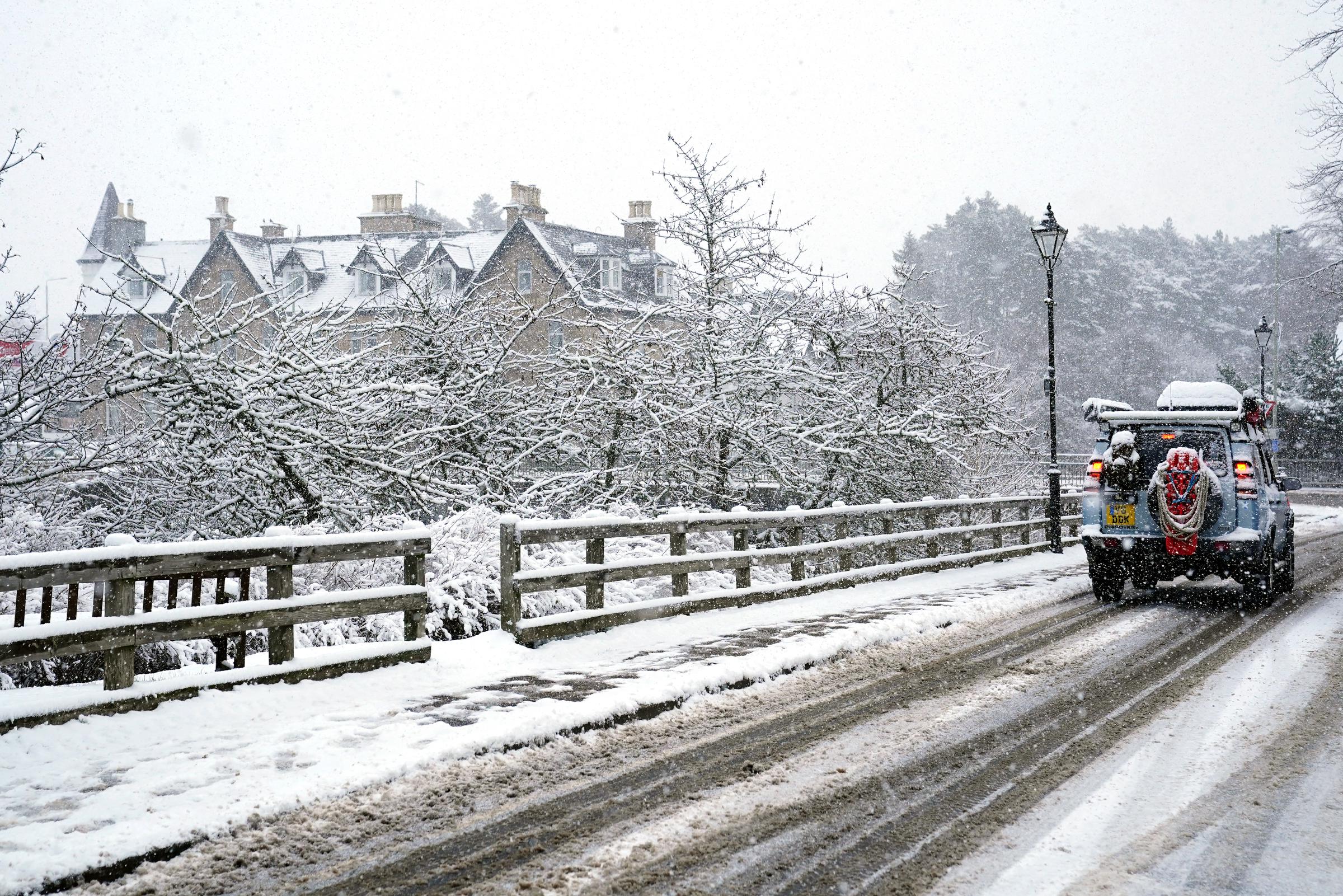 A car driving through snow in Carrbridge in the Scottish Highlands on November 19, 2025. | Source: Getty Images