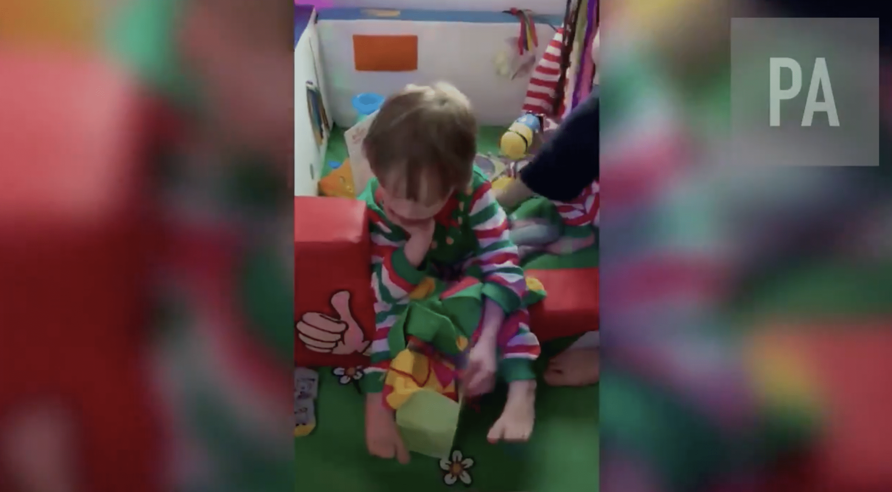 One of Mullard's twin boys is seen playing with toys. | Source: twitter.com/PA